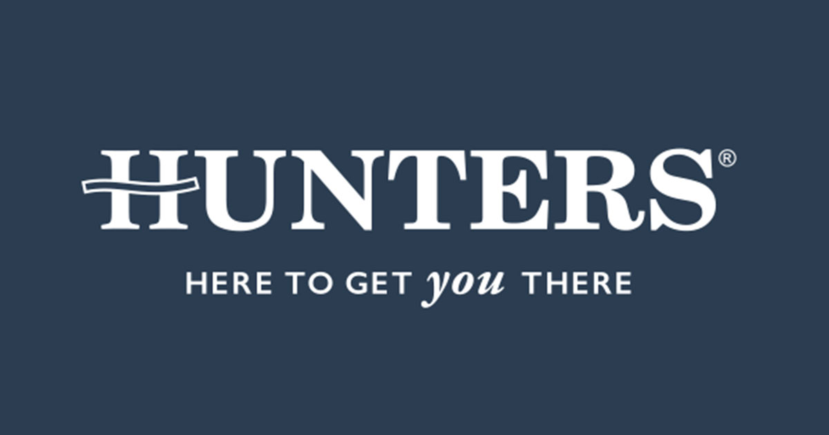 Logo for Huntress with the slogan 'Here to get you there' on a dark blue background