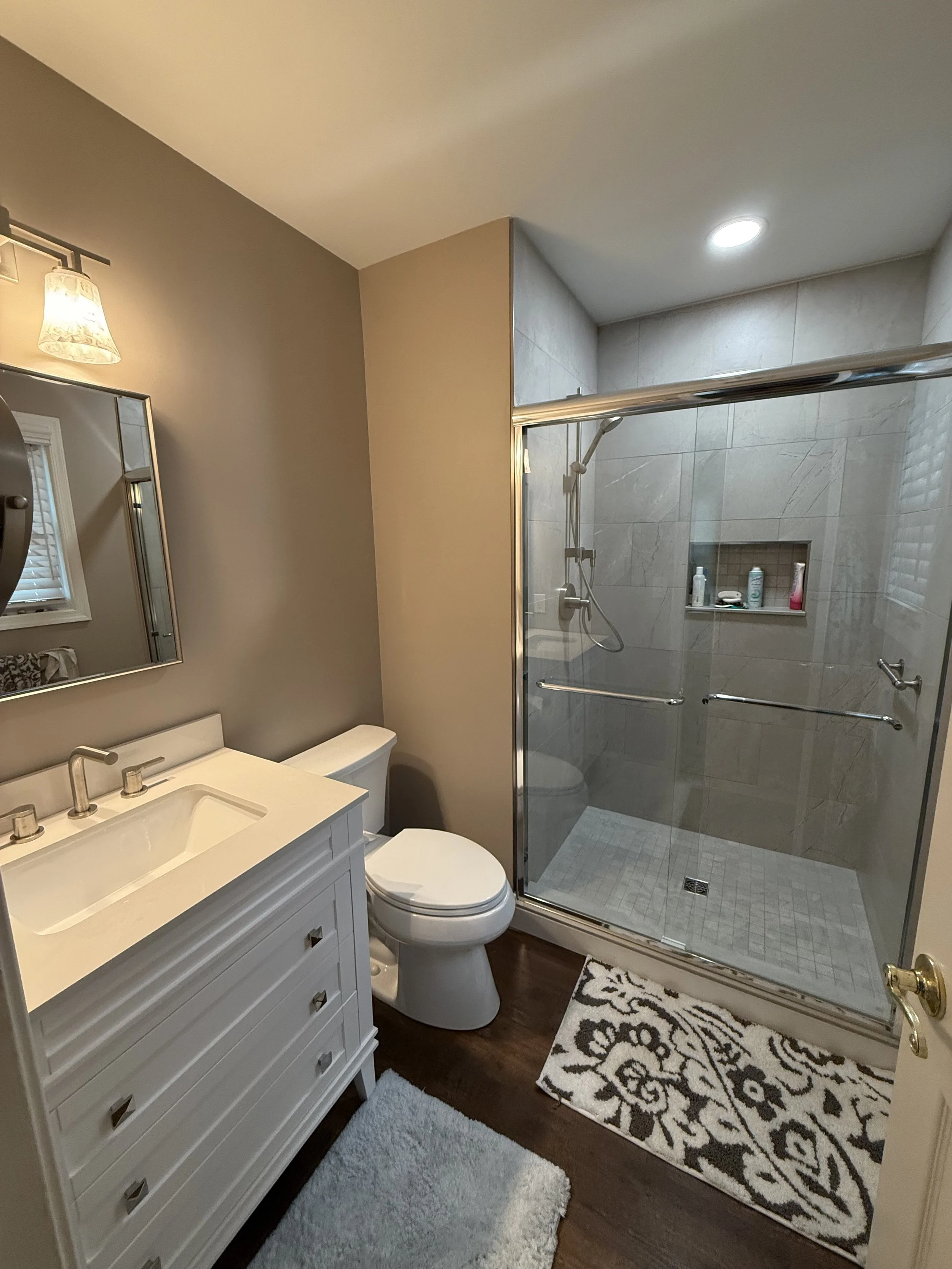 Completed primary bathroom remodel featuring custom shower and tile flooring in Brick NJ