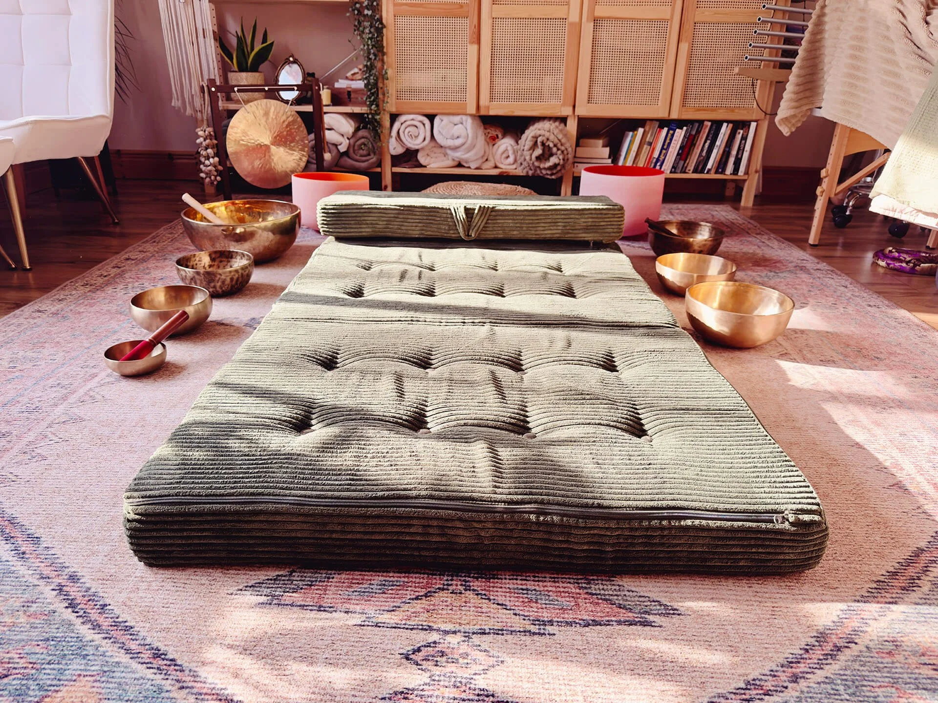 Ready for a sound healing treatment with a large soft mattress for the client. Tibetan singing bowls, crystal bowls and a gong surround the mattress