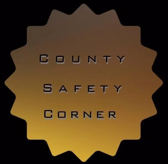 Gold badge with black text that reads "County Safety Corner"