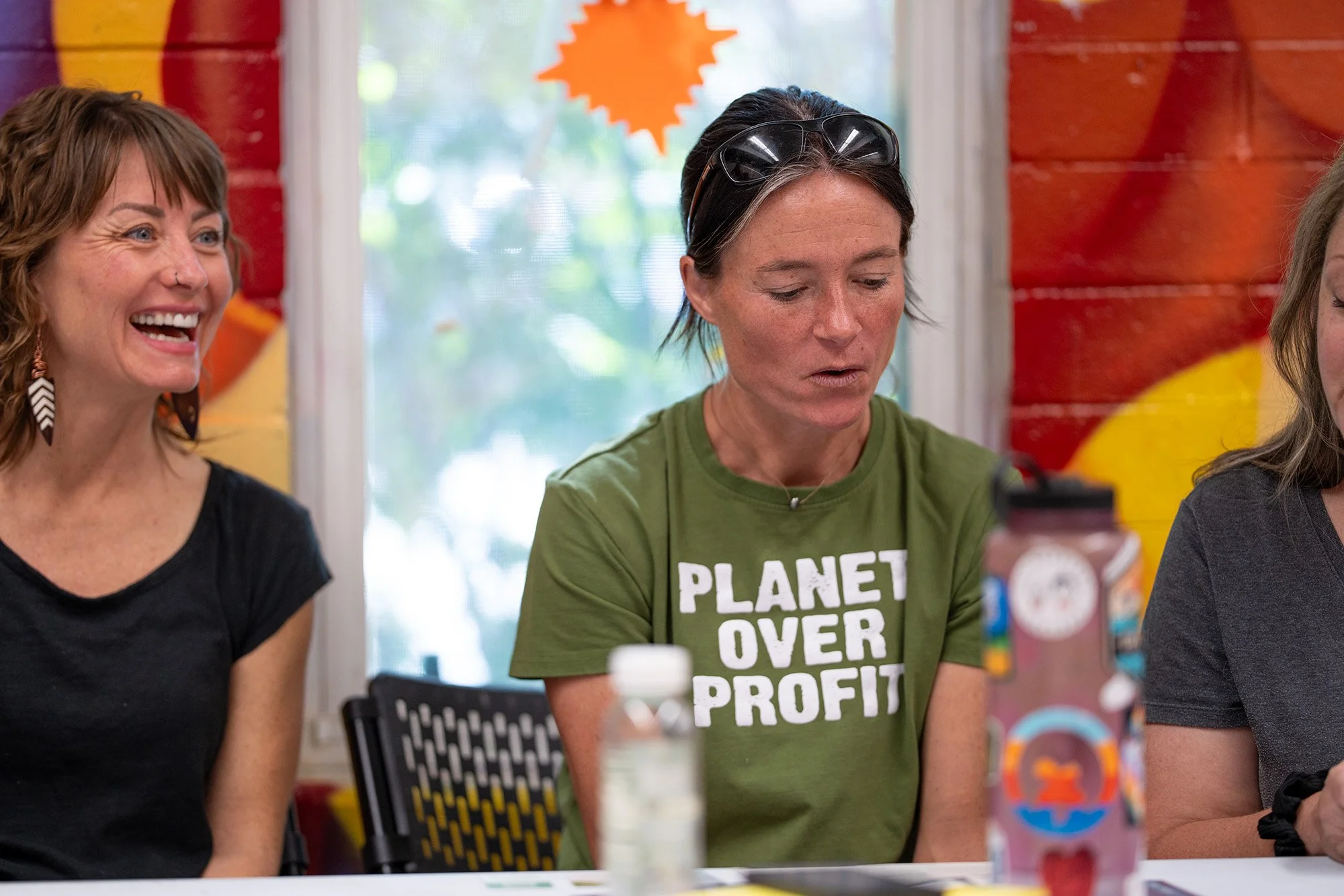 Person on a panel wearing a "Planet over profit shirt"