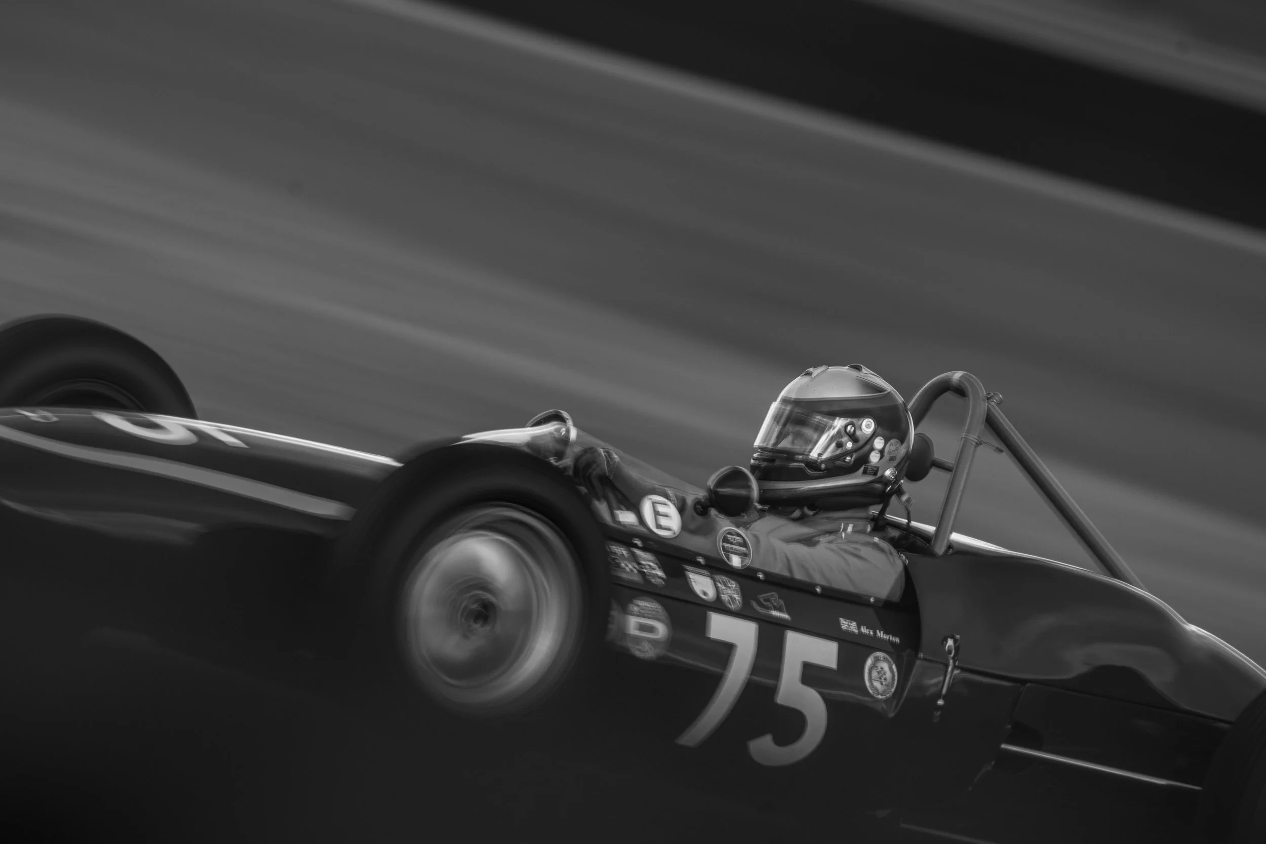 Black-and-white photograph of classic single-seater number 75 at Silverstone.