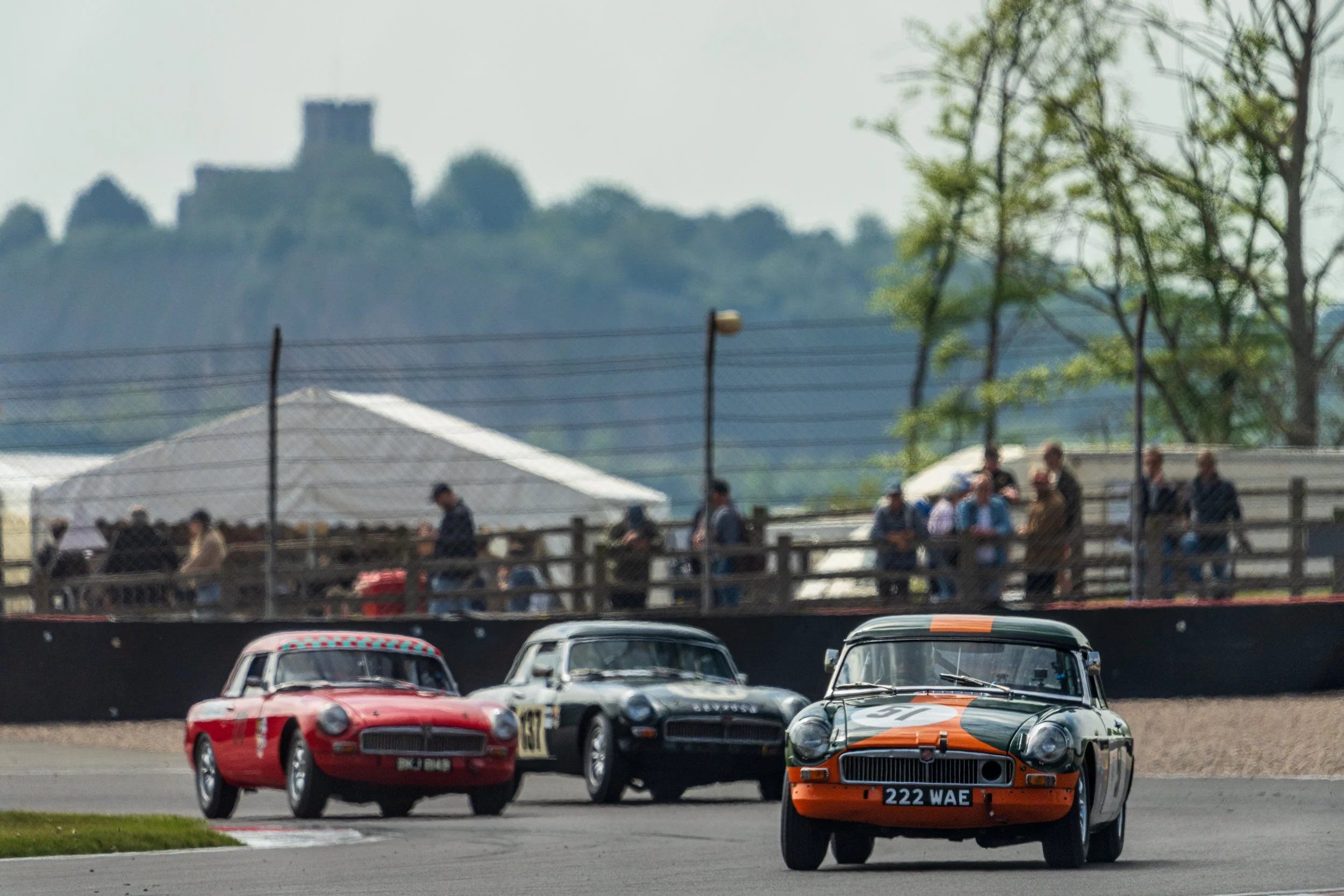 Historic touring cars approaching together at Donington Historic Festival.