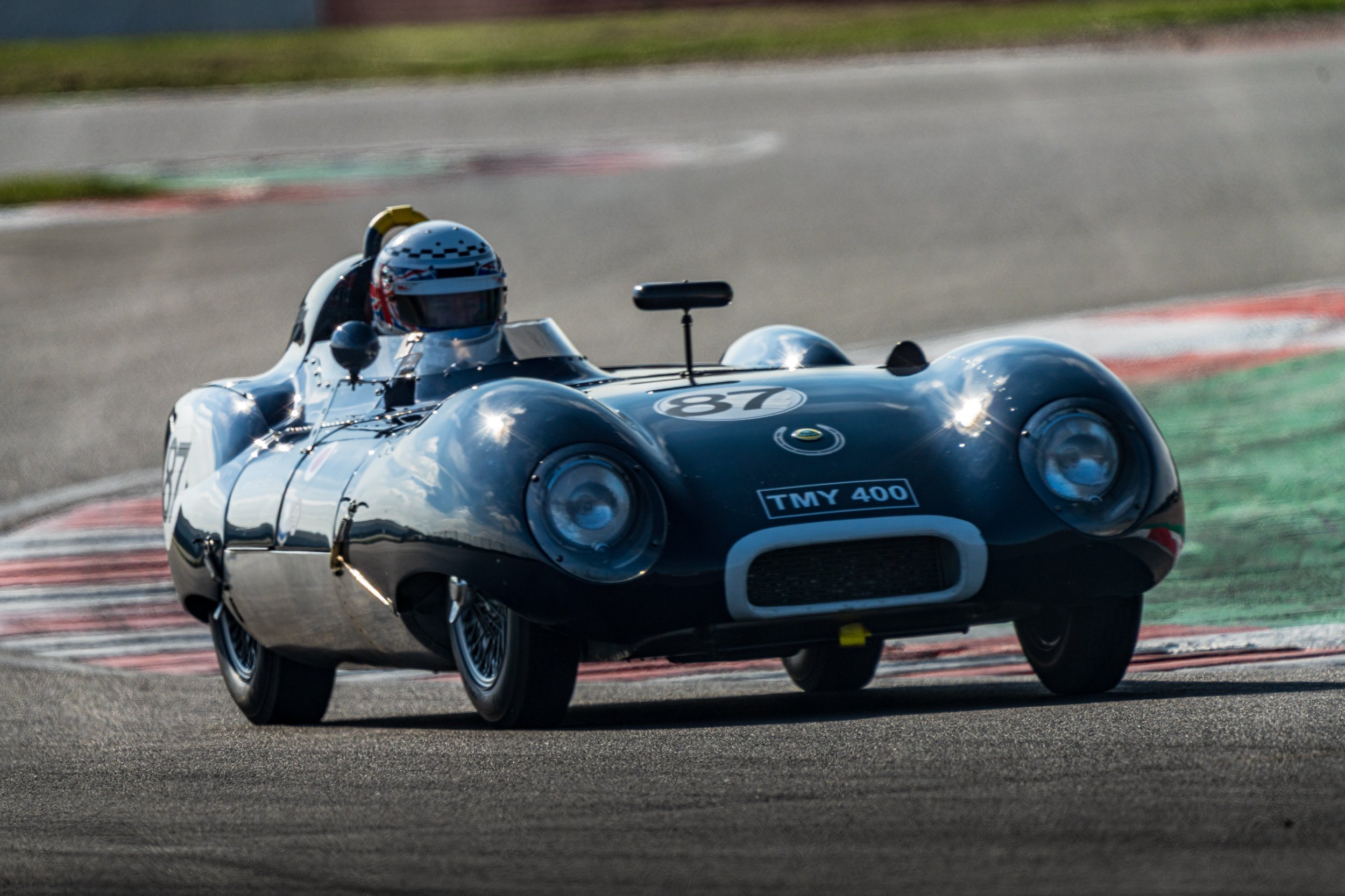 Blue open-top historic sports racing car on track at Donington Park.