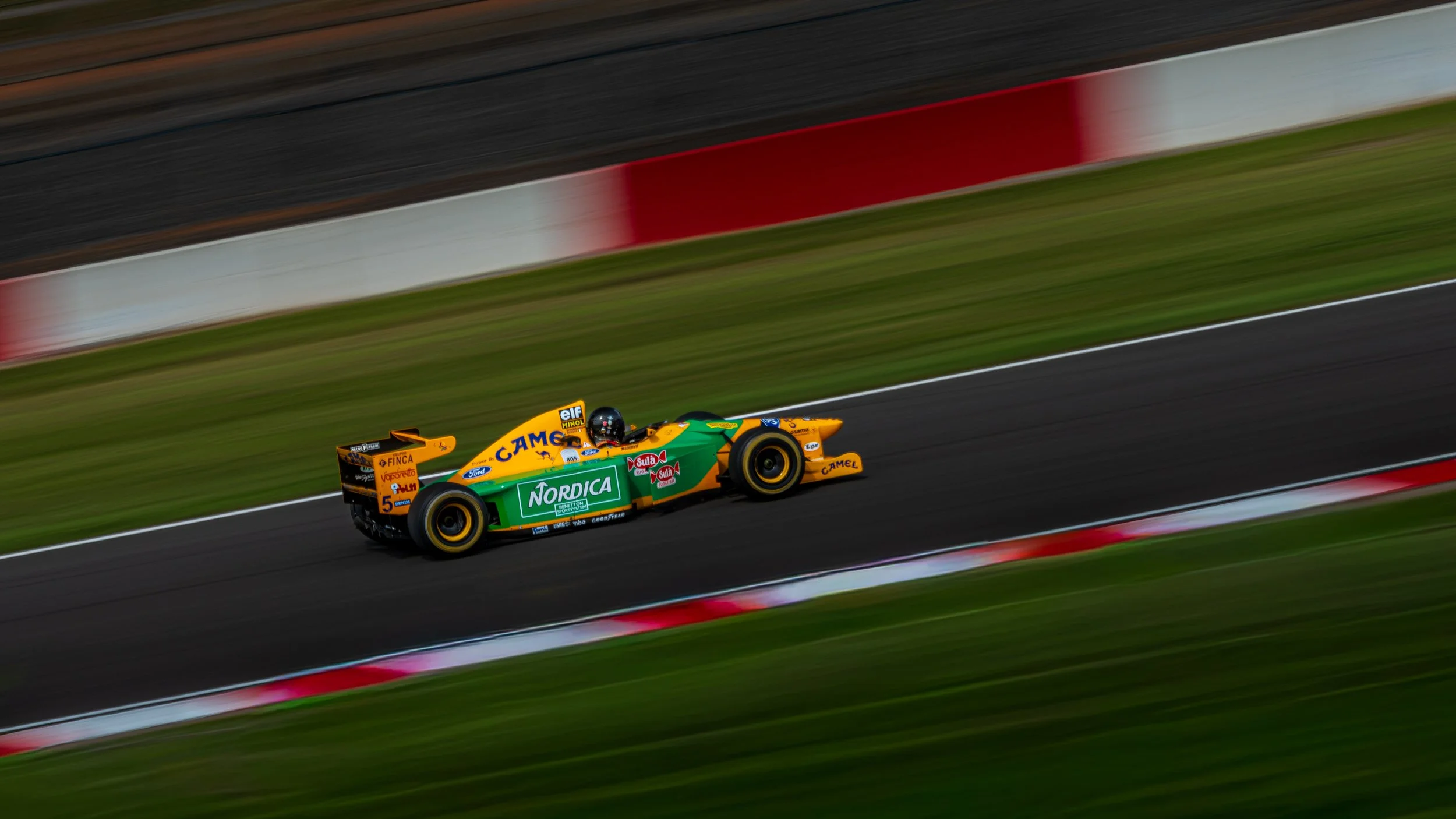 Green and yellow classic single-seater captured at speed at Donington Park.