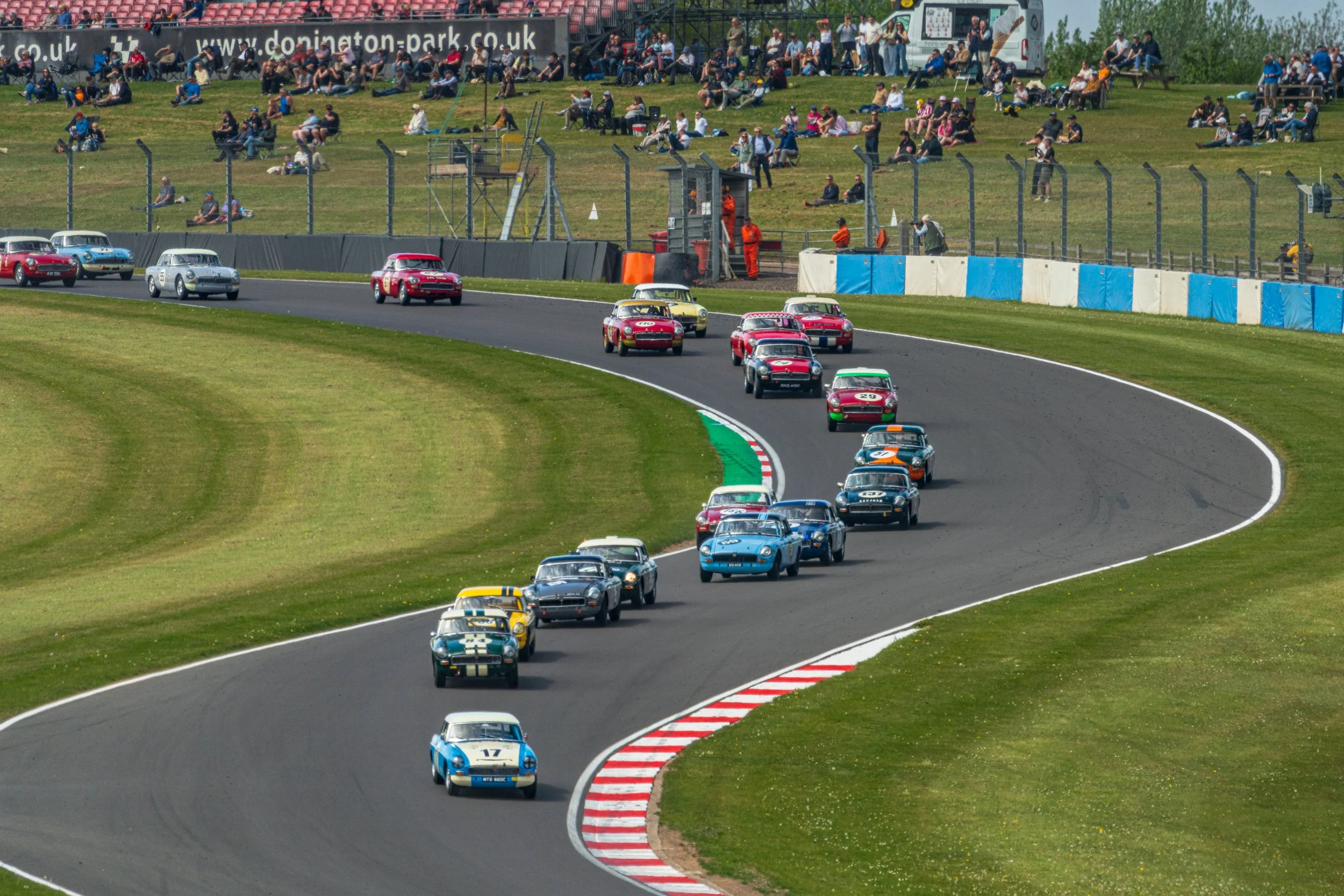 A field of classic touring cars winding through Donington Park’s chicane.