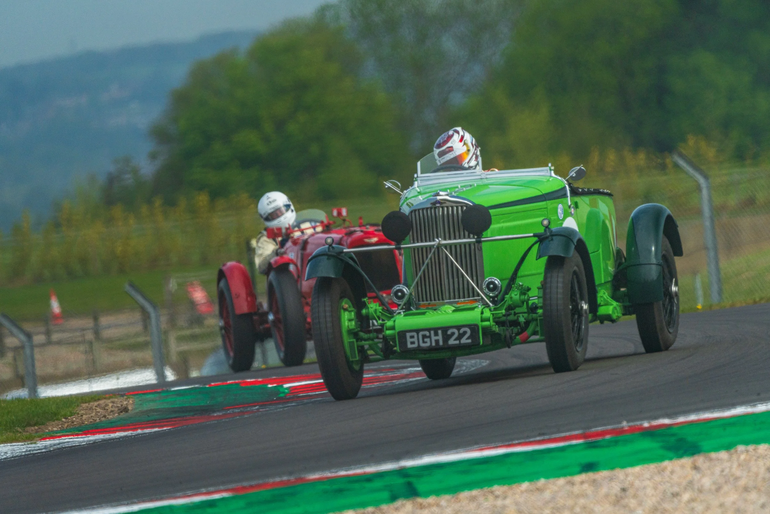 Green pre-war racing car competing at Donington Historic Festival.