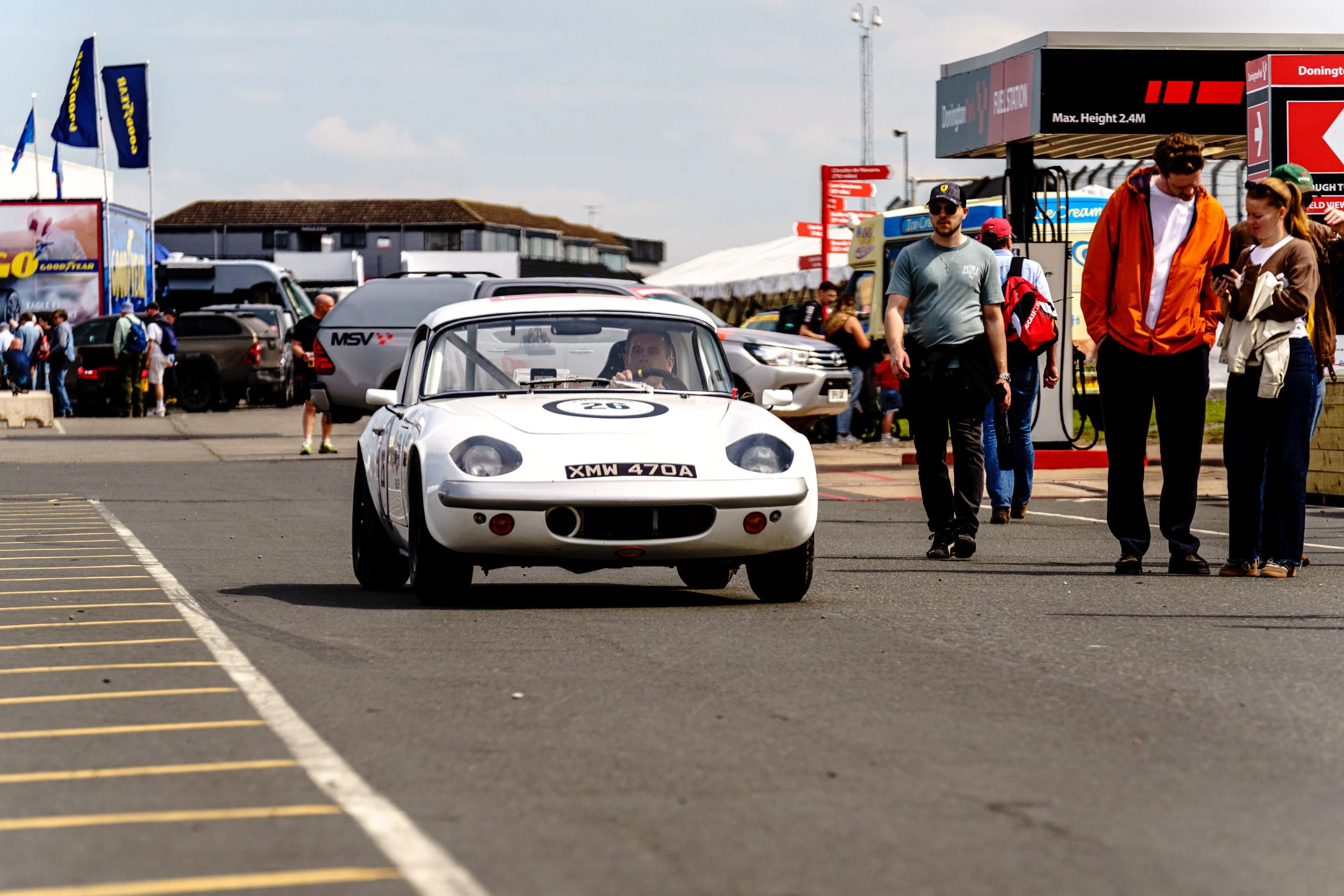 White sports racing car and team members in the Donington Park pit lane.