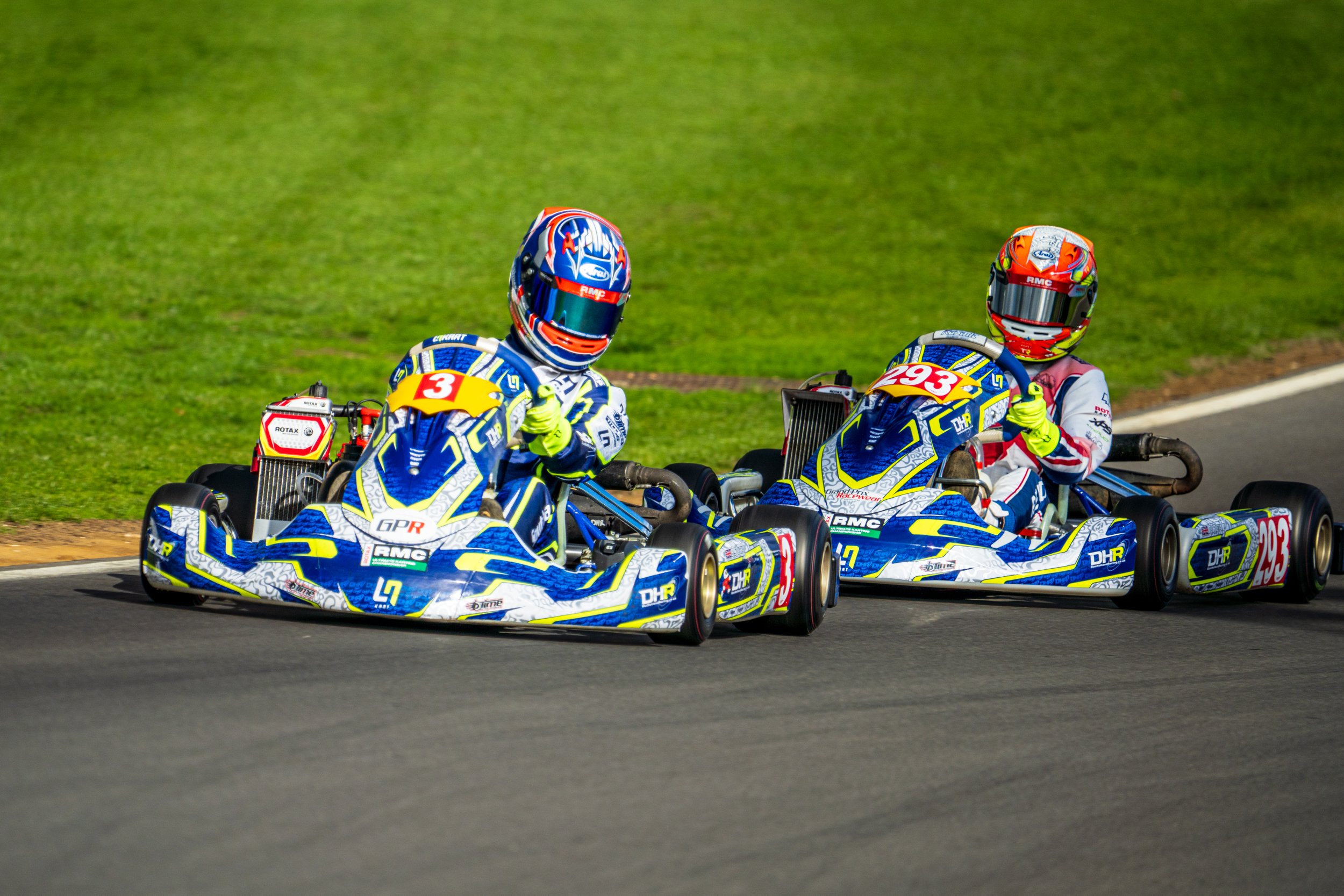 Two blue and yellow karts competing at Silverstone.