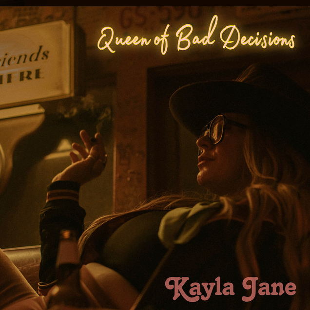 A woman with long hair, wearing sunglasses and a wide-brimmed hat, lounging on a sofa with a bottle nearby. She is in a dimly lit room with a neon sign that reads 'Queen of Bad Decisions' above her. There is a sign on the wall that is partially visible.