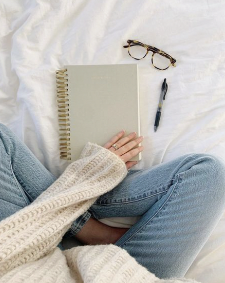 Woman sitting with notes considering a Substack audit