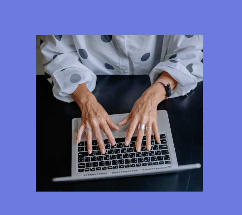 Woman typing on computer for a Substack audit