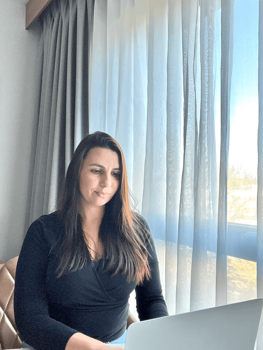 Dimka Dimitrova working on a computer helping clients grow their Substack