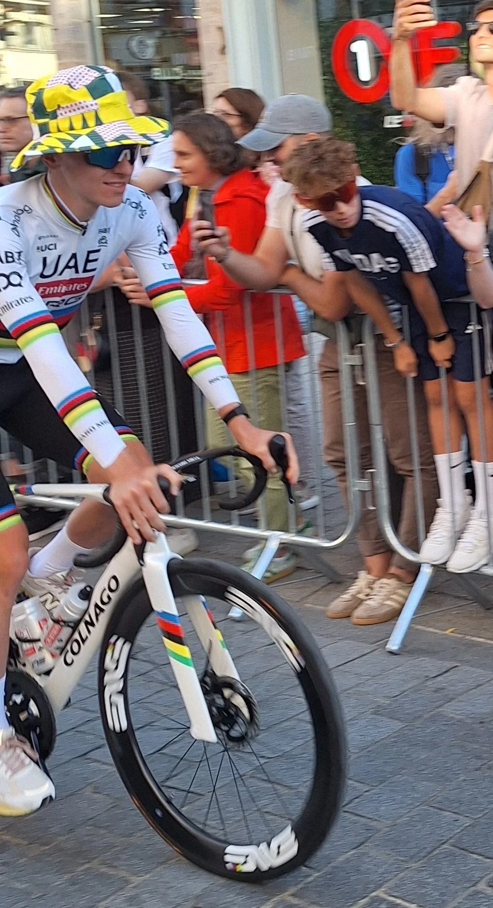 World Champion Tadej Pogacar rides by in the ceremonial parade to launch the 2025 Tour de France