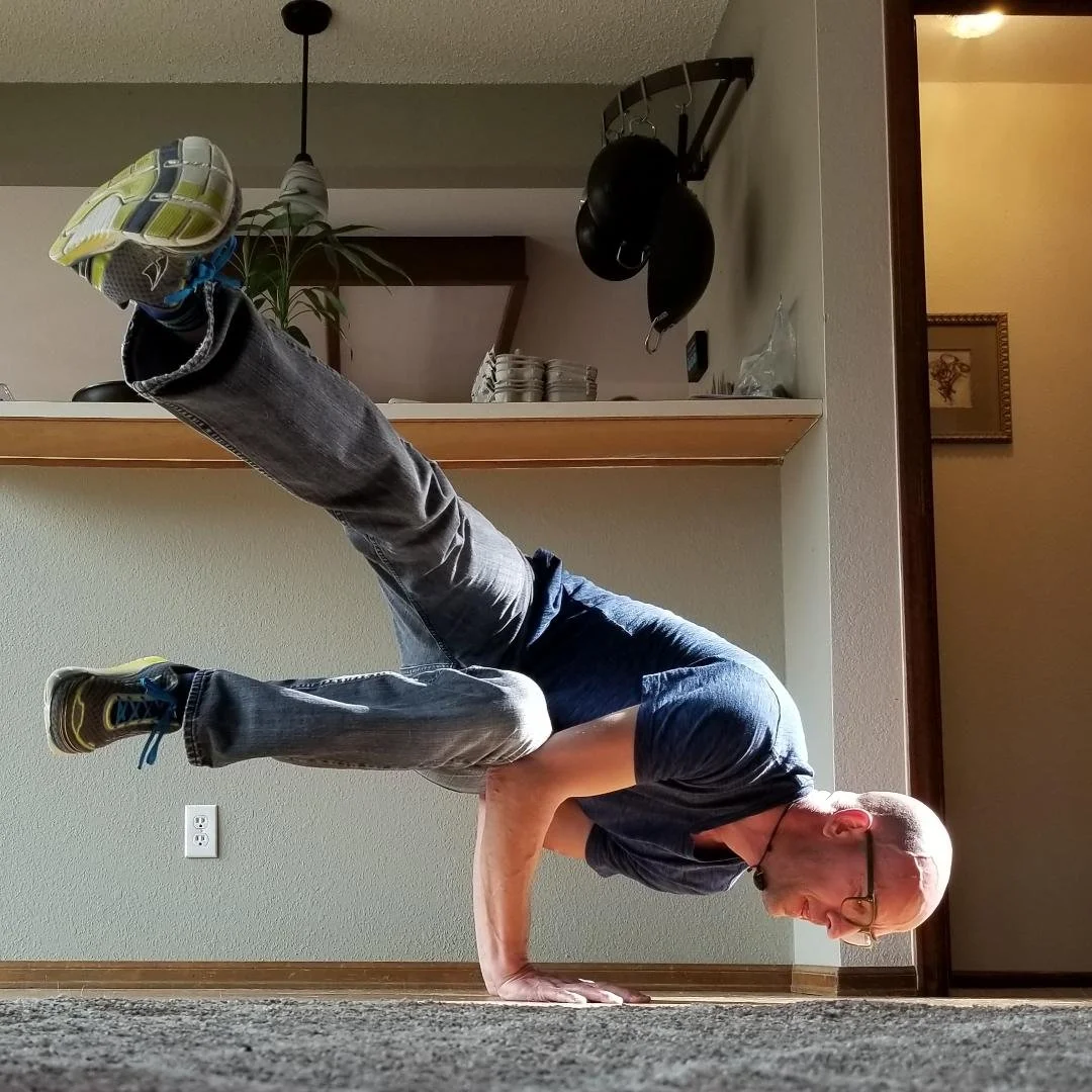 A man doing a yoga pose in a living room.