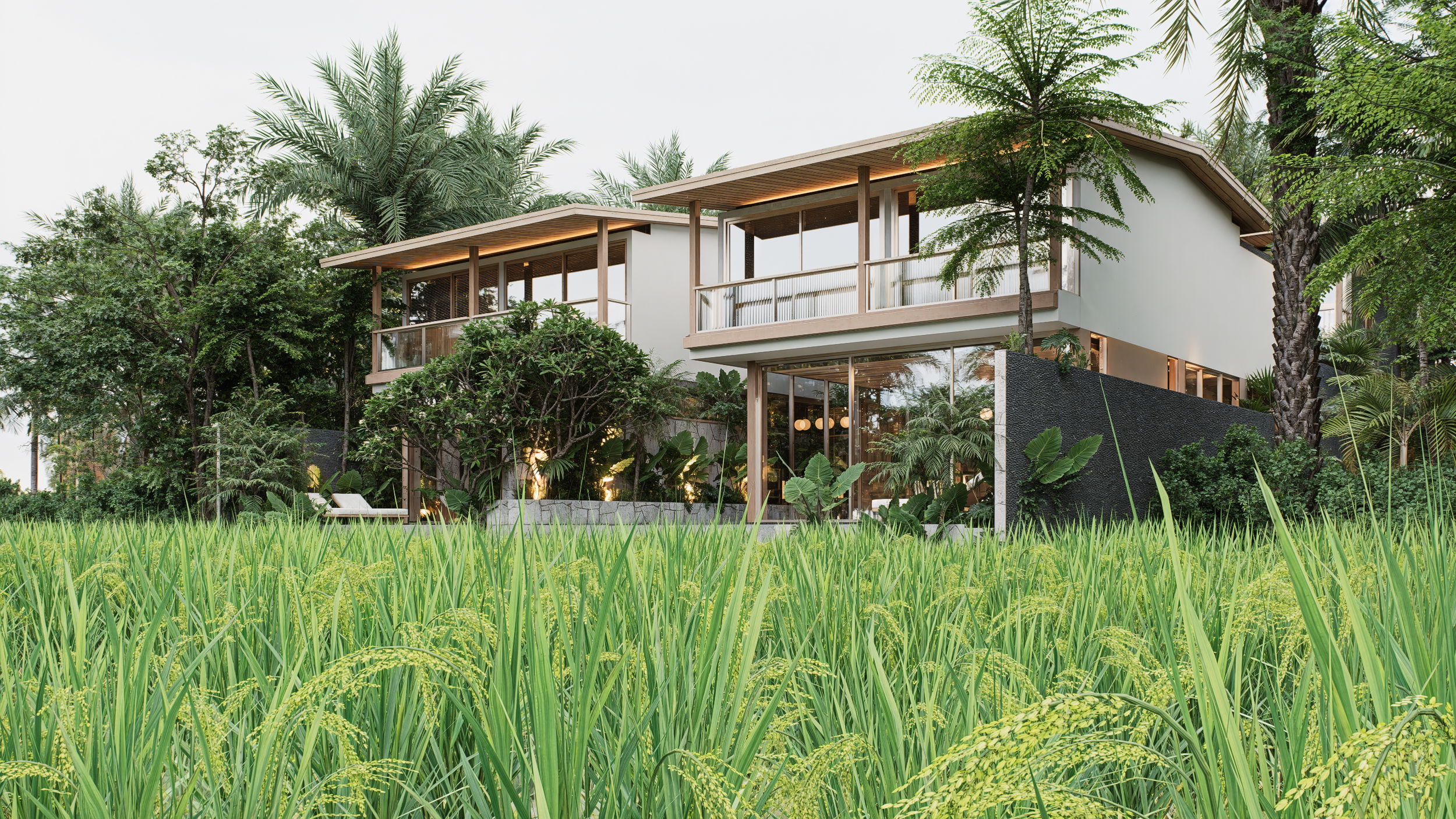 Modern house with large windows and wooden accents, surrounded by lush green trees and grass.
