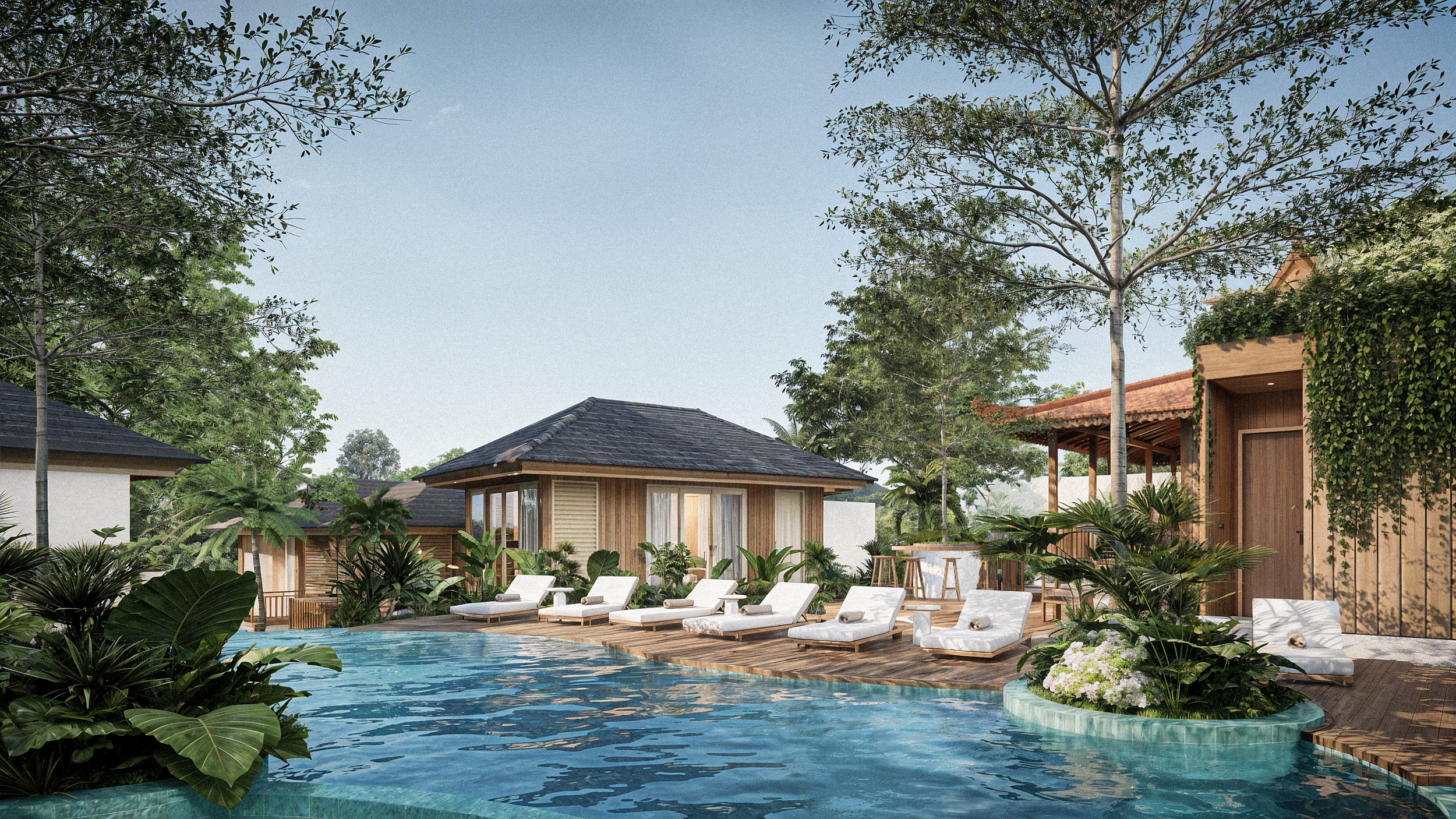 A luxurious outdoor pool area surrounded by tropical plants and trees, with white lounge chairs and a wooden poolside bar or cabana.