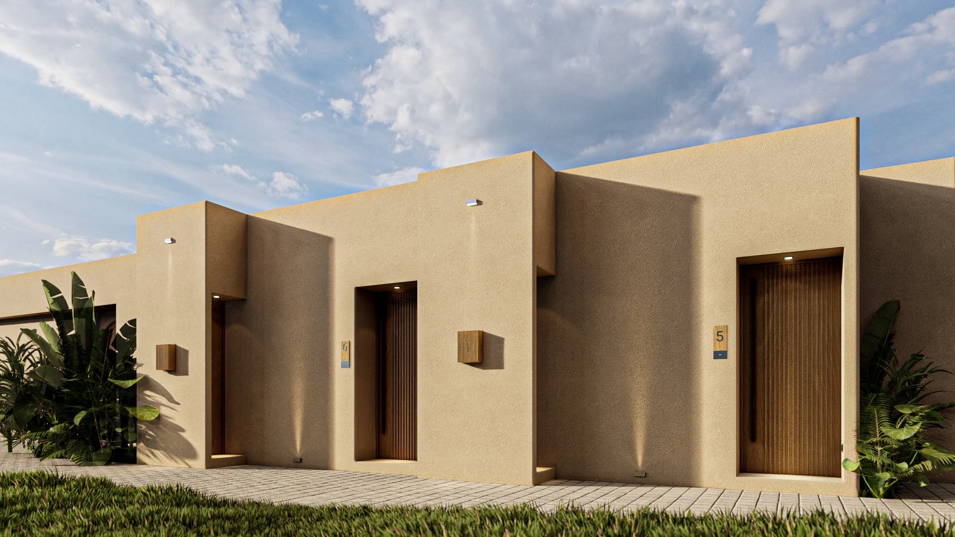 Modern beige townhouses with vertical wooden doors, small wall-mounted lights, and surrounding greenery under a partly cloudy sky.