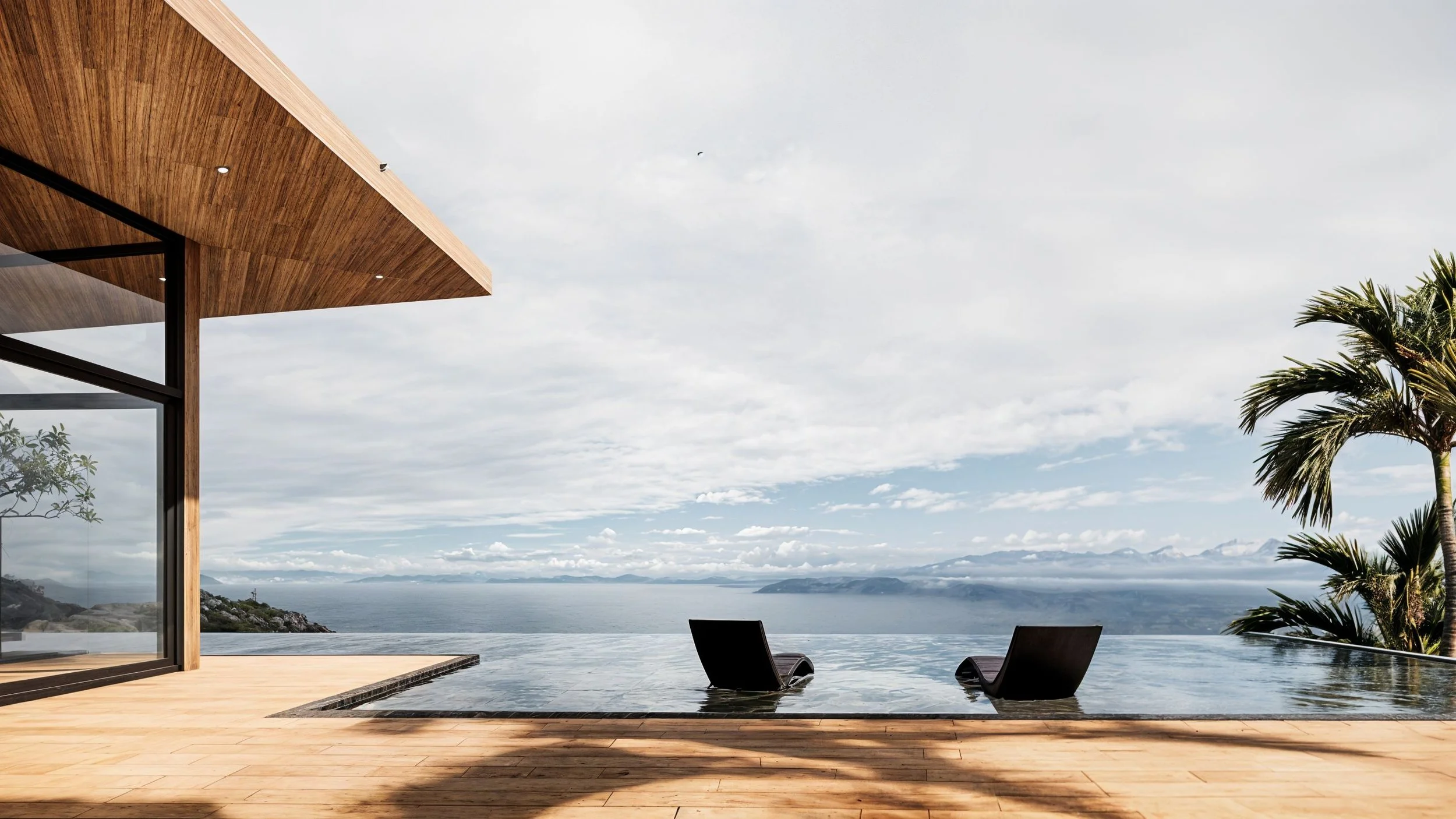 A modern outdoor pool area with two lounge chairs facing a panoramic ocean view, with mountains in the distance, a palm tree on the right, and part of a wooden-roofed structure on the left.