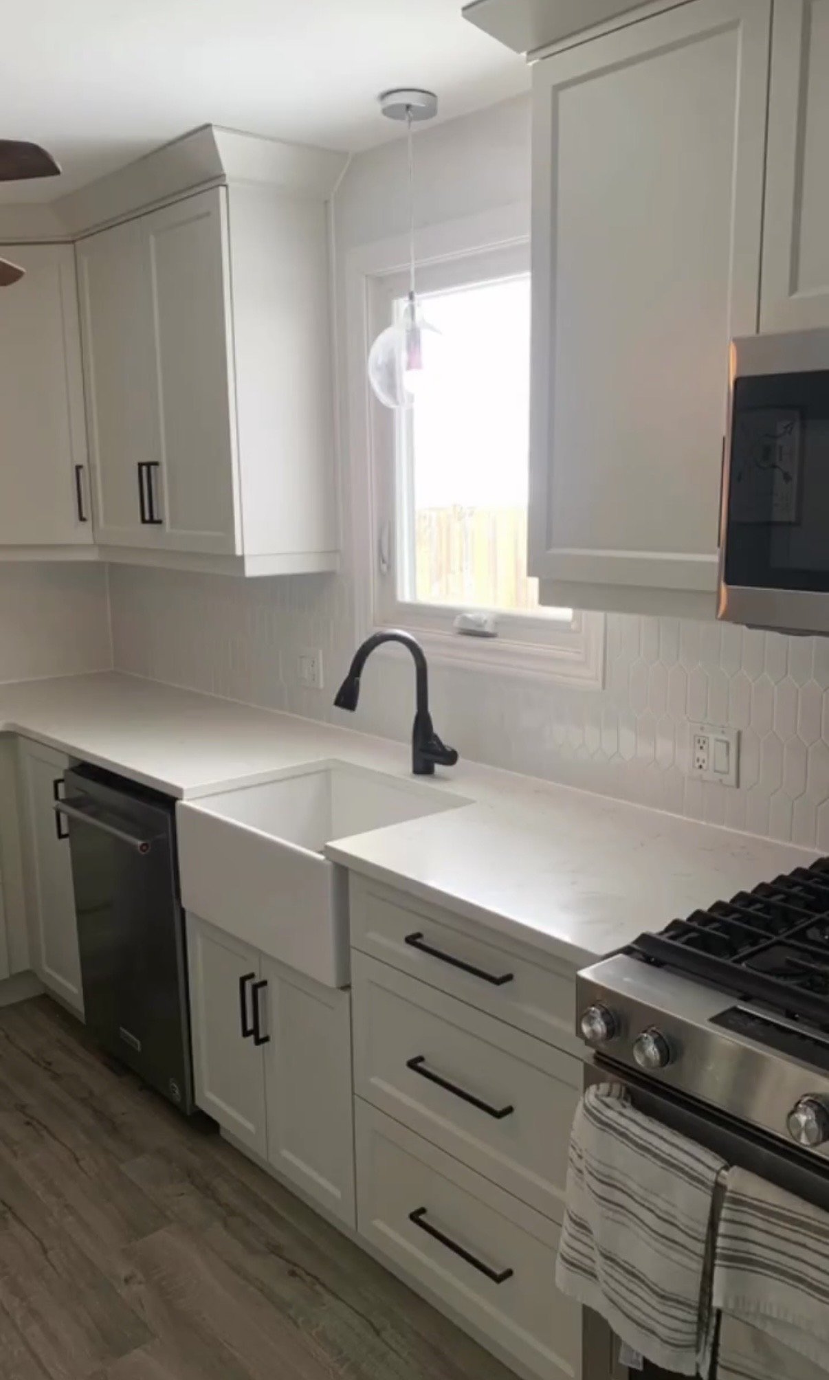 White tiled kitchen backsplash, countertops, flooring, design. 