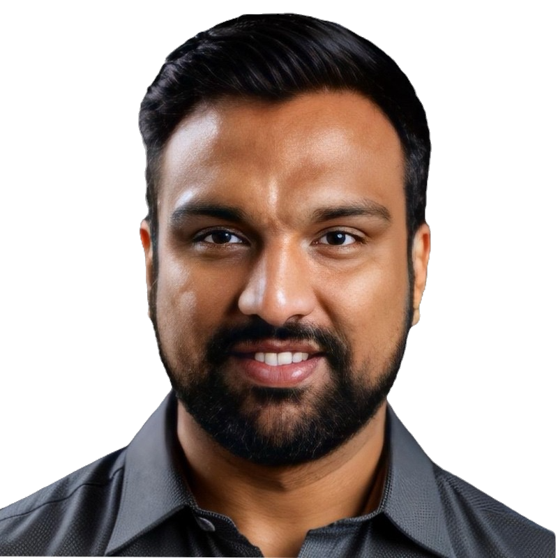 Close-up portrait of a smiling man with dark hair and beard, wearing a dark collared shirt, against a black background.