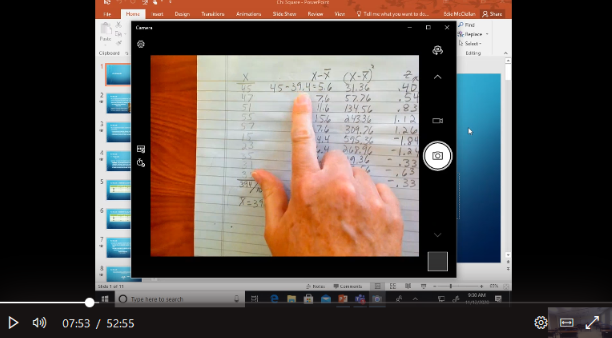 A professional educator demonstrates synchronous learning strategies on a laptop during an institutional LMS migration managed by CohnDriven Learning Architecture.