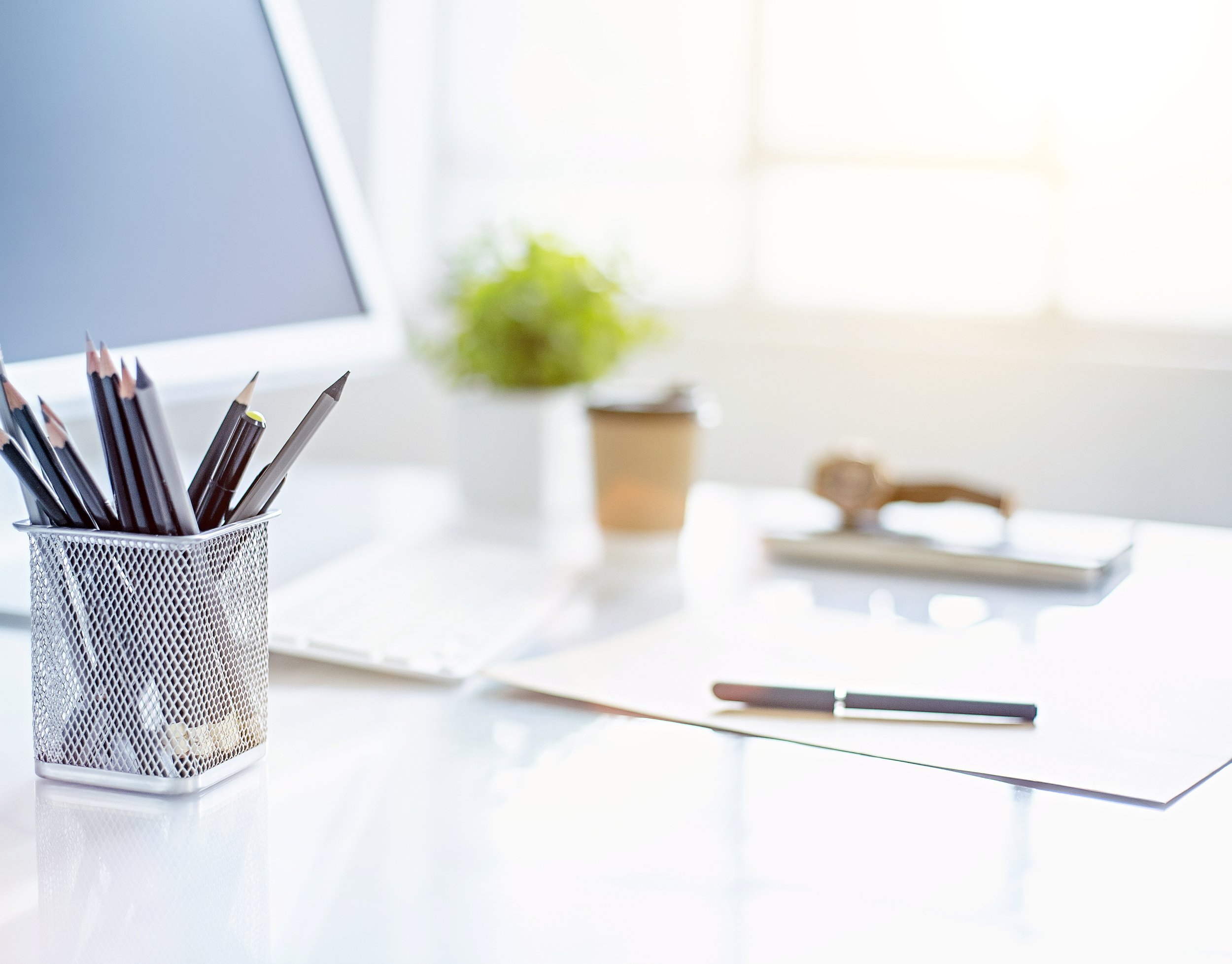 Get NorthStar Virtual Solutions clear desk with paper pens plant and computer