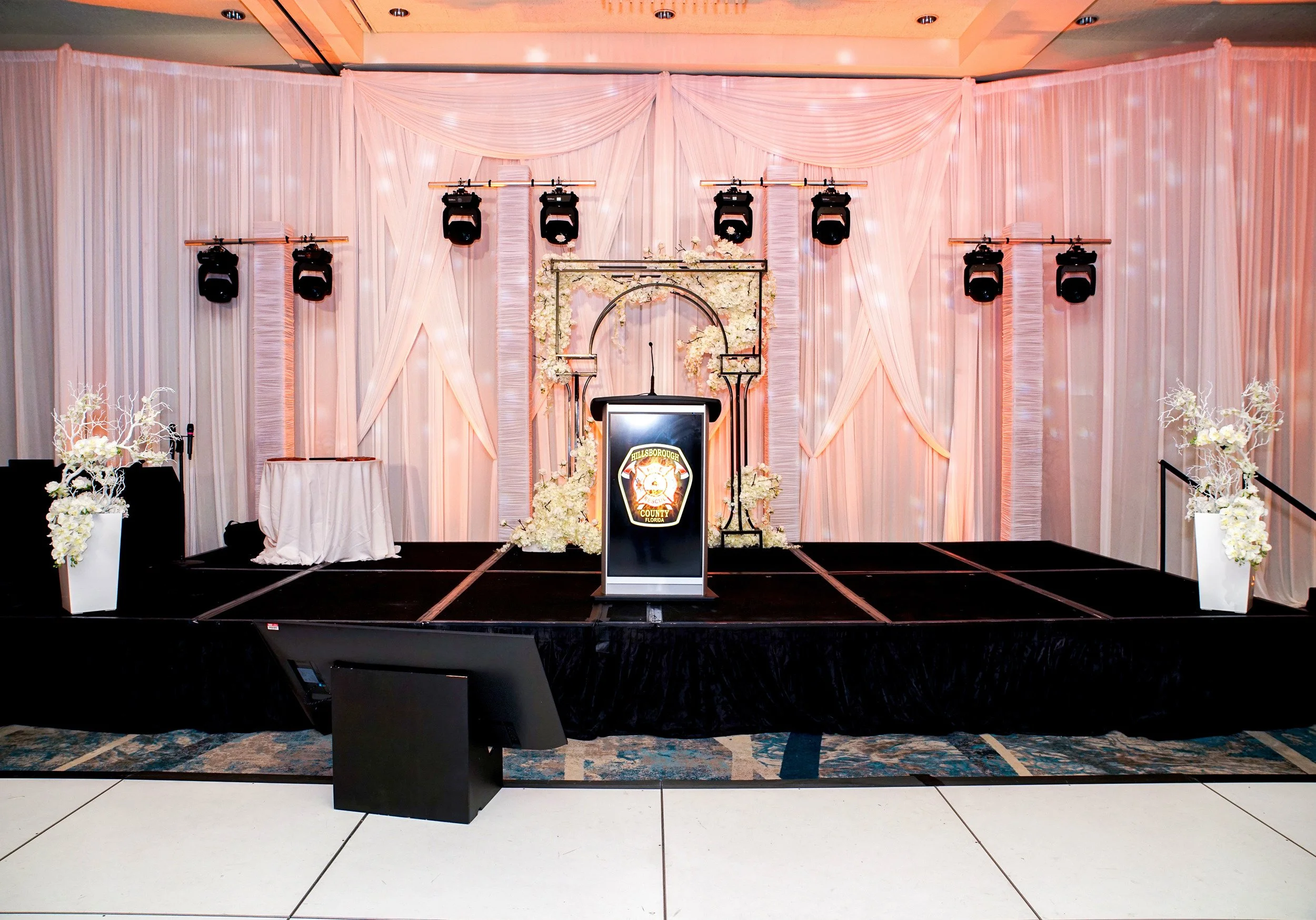 Professional DJ, sound, moving head lighting, trussing, and scrim setup for a corporate event at the Hilton Tampa Downtown