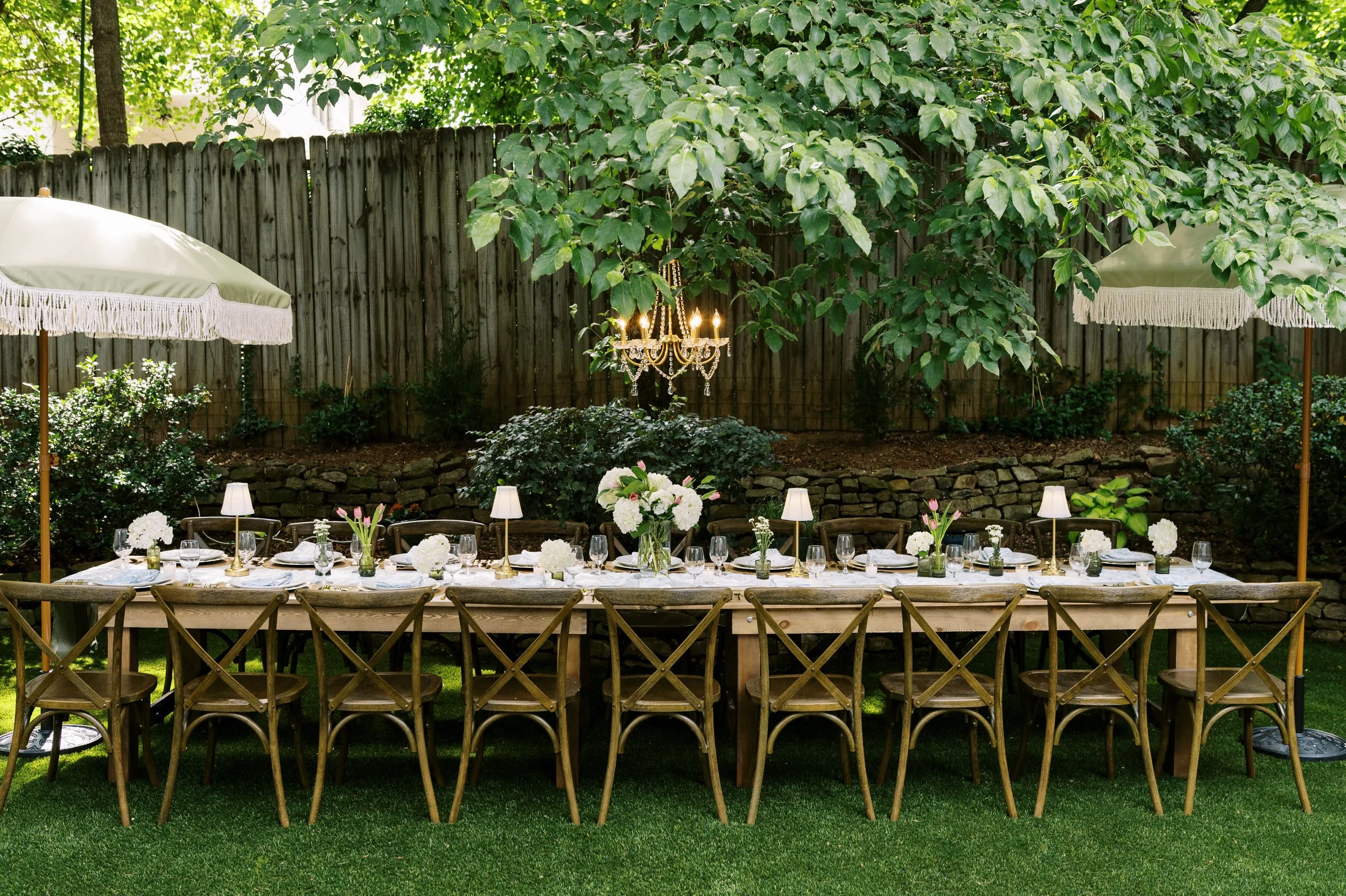 Styled tablescape with gold flatware, charger plates, and linen napkins — boutique rentals Atlanta GA