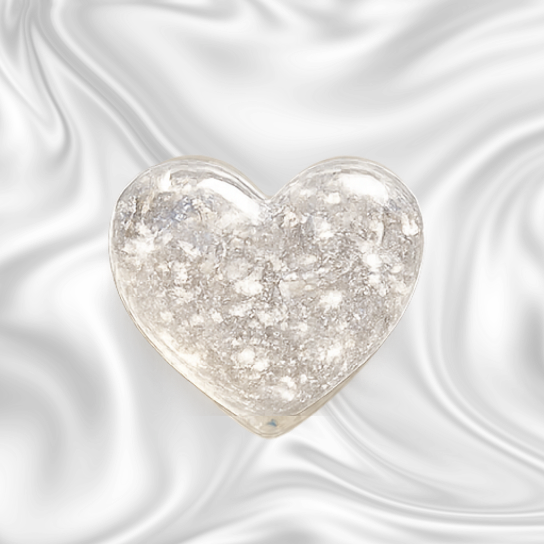 A luminous heart-shaped object resembling the moon, set against a dark, swirled background.