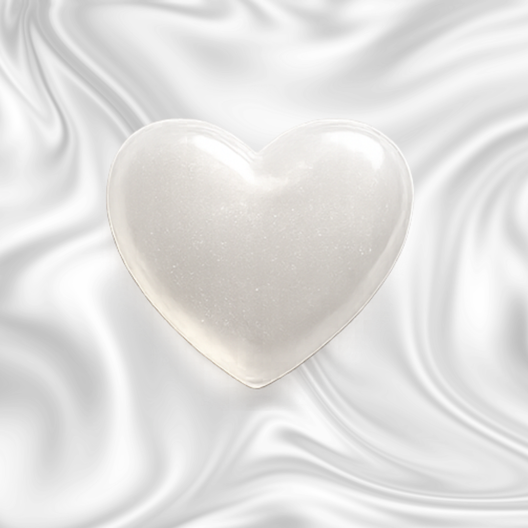 A glowing white heart with a smooth surface, set against a dark marbled background.