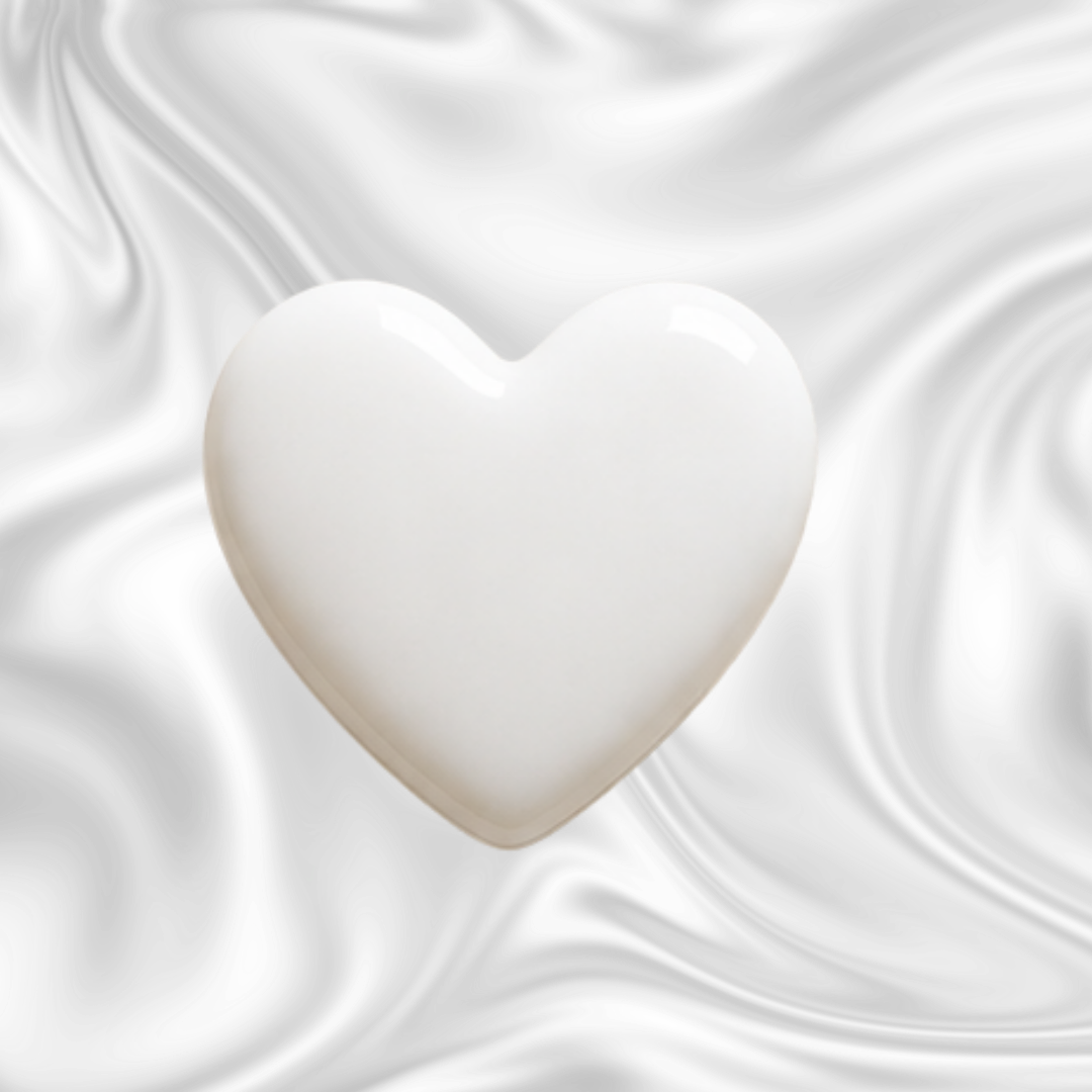 A white heart-shaped object against a black and gray marbled background.