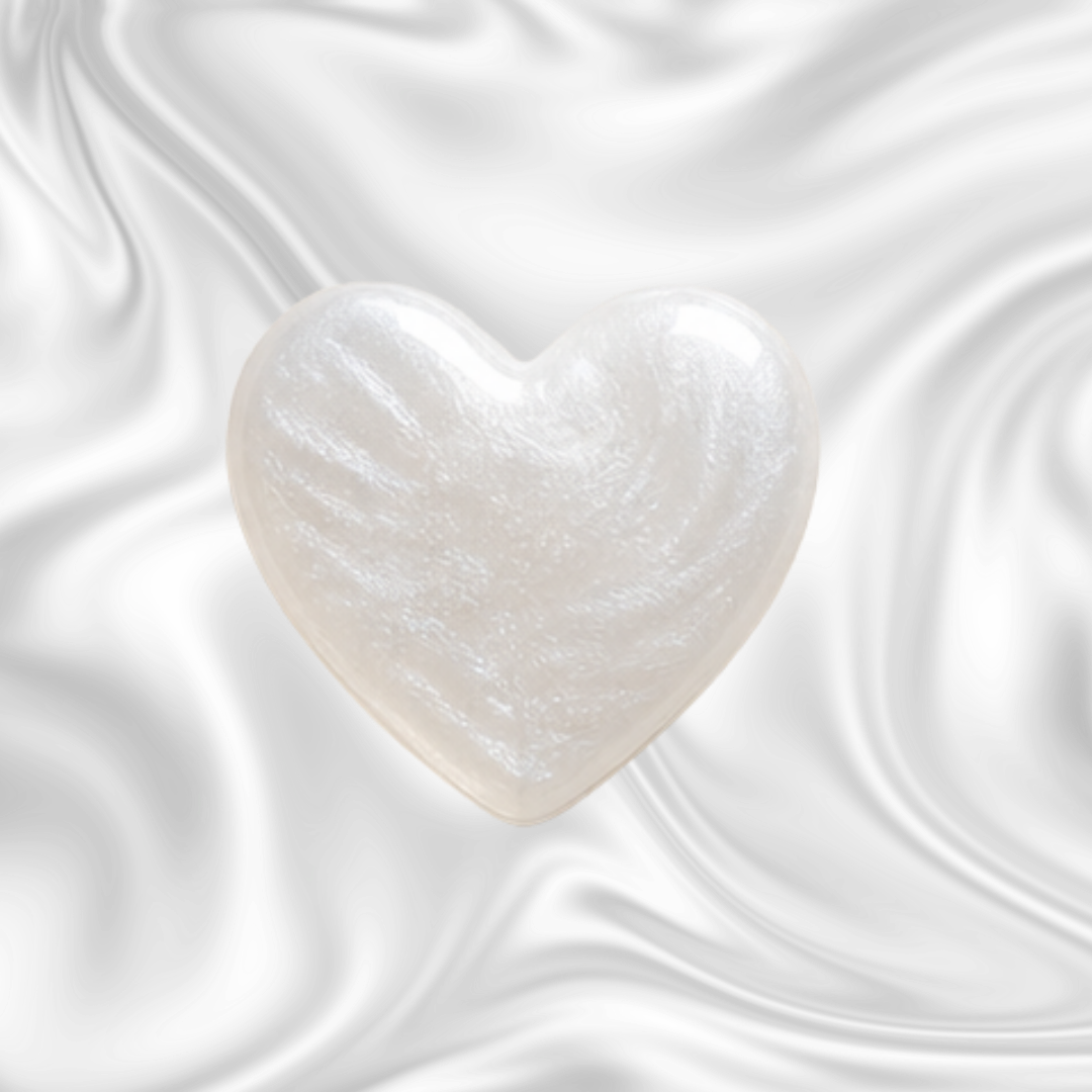 A white heart-shaped object against a black and gray swirling background.