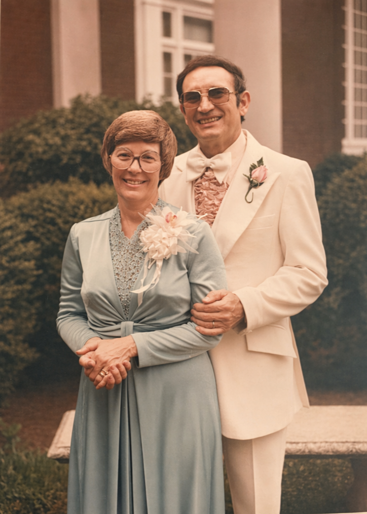 a couple in the 1980s outside dressed up for a wedding