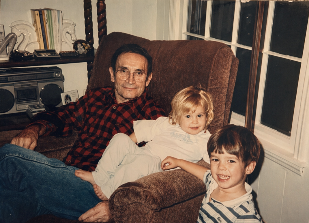 gvb founder, Jen, laying with grandfather in recliner next to her brotherin their house in Franklin, Tennessee