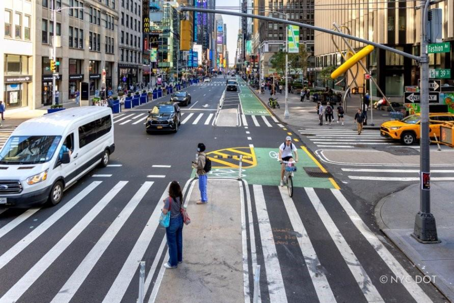 Photo of a cyclist, two pedestrians and three cars on 7th avenue