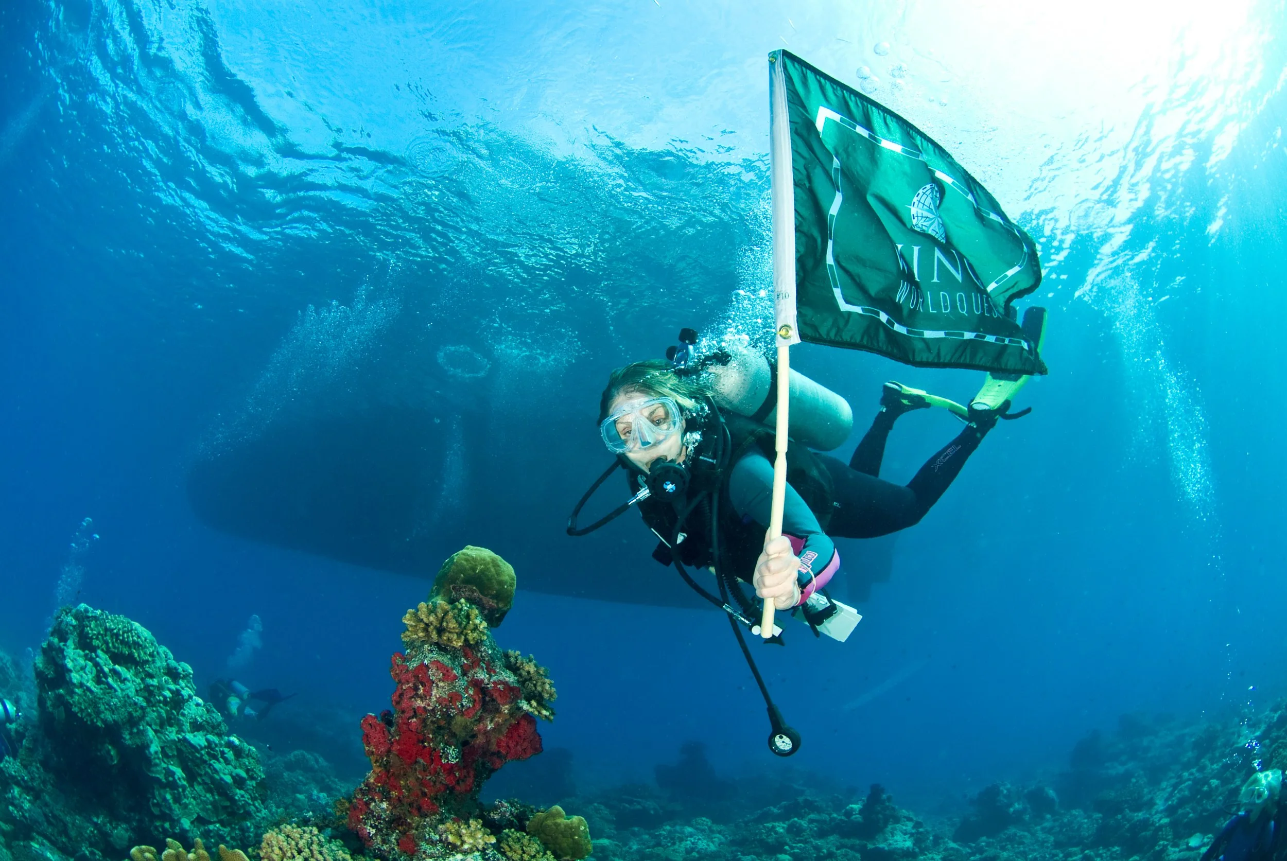 PAPUA NEW GUINEA  swimming underwater the WINGS WORLDQUEST Flag for women explorers