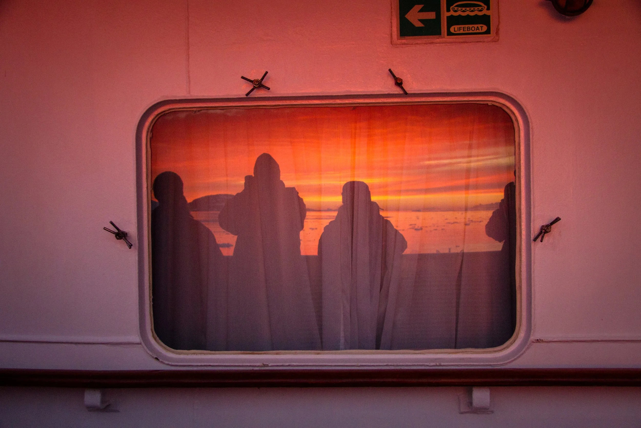  ANTARCTICA our sunset reflections in porthole on shipboard 