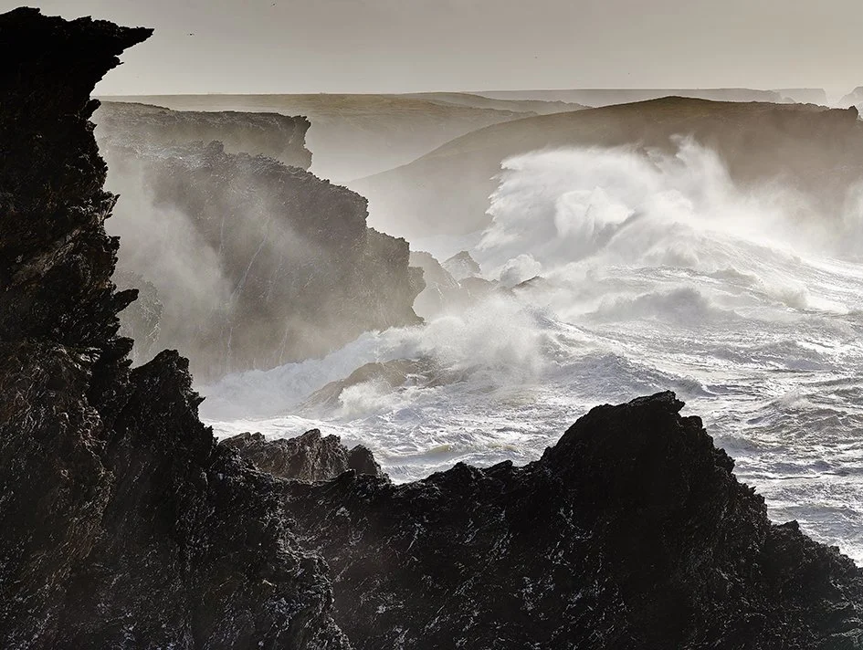 Vagues déchaînées contre des falaises rocheuses.