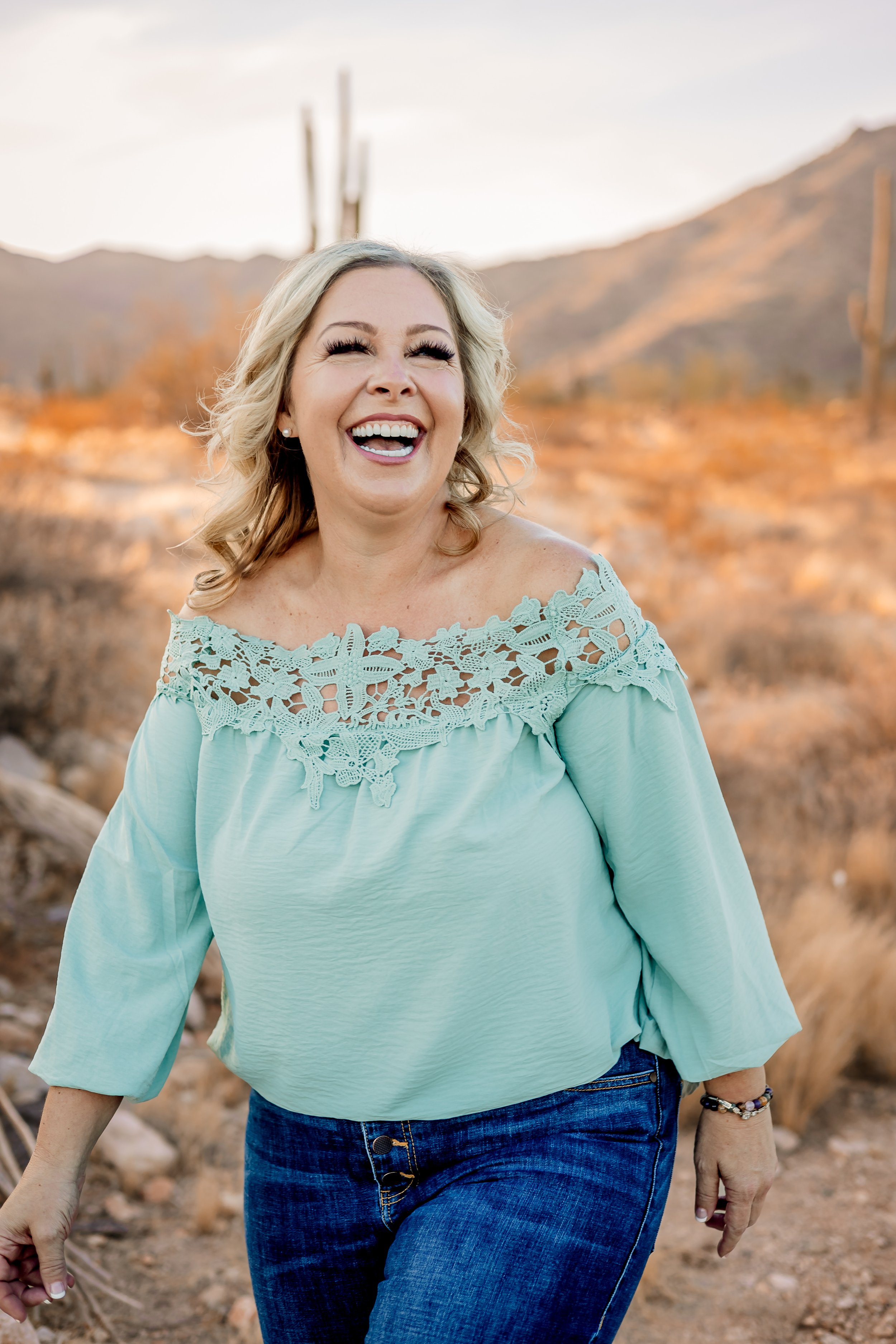 Amy Summers, founder of Awareness with Amy, smiling outdoors in the Arizona desert