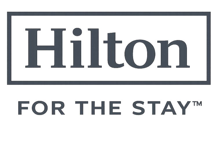 The image shows a sign with the word "Hilton" at the top and the phrase "For the Stay" below it.
