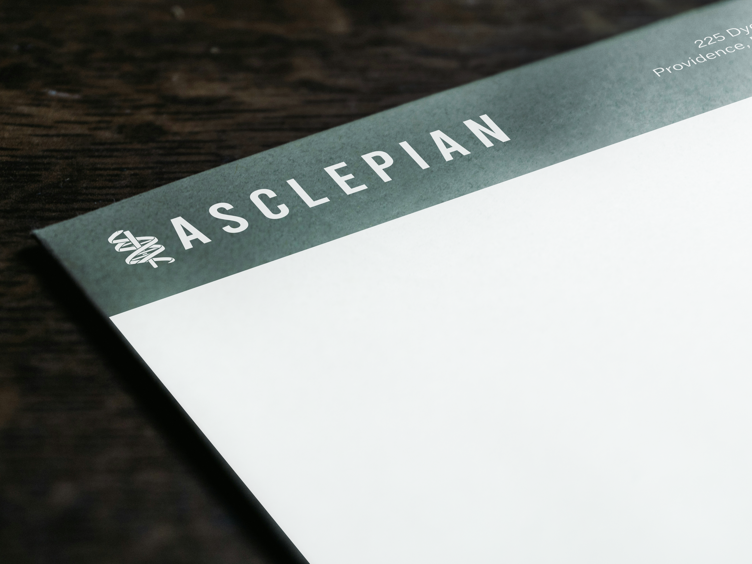 Close-up of a health insurance claim form or letter with the heading 'ASLOWEPHAN' and a small logo on a wooden surface.