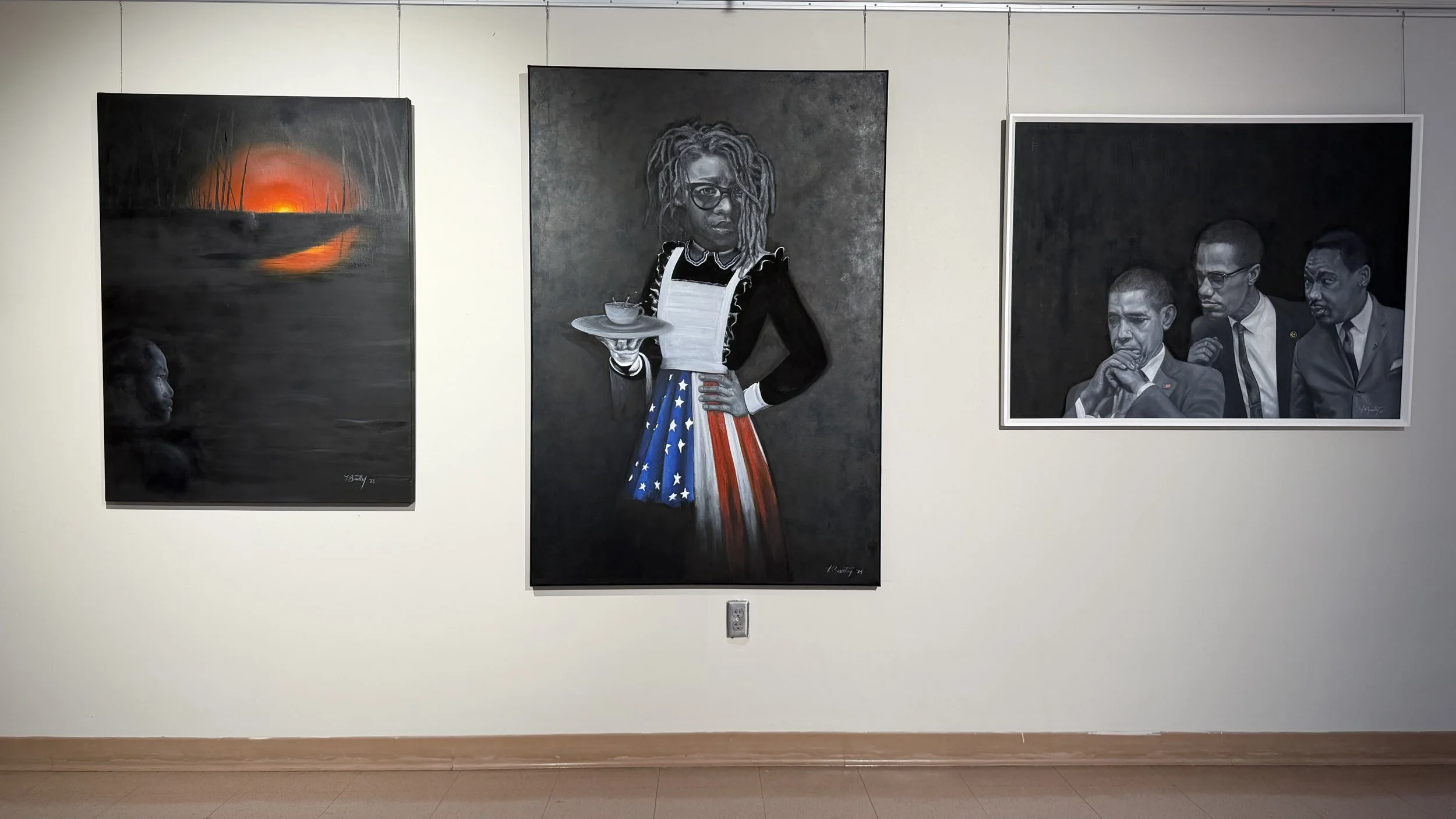 Three paintings displayed on a white gallery wall. The left painting depicts a sunset over a dark landscape with a person's face emerging from water. The center painting is a portrait of a woman with dreadlocks, glasses, and a dress with an American 