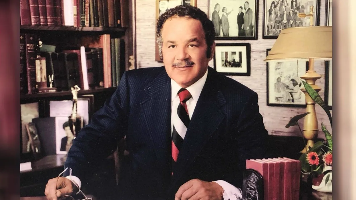 Bruce R. Watkins, Kansas City civil rights leader and political activist, seated at his desk