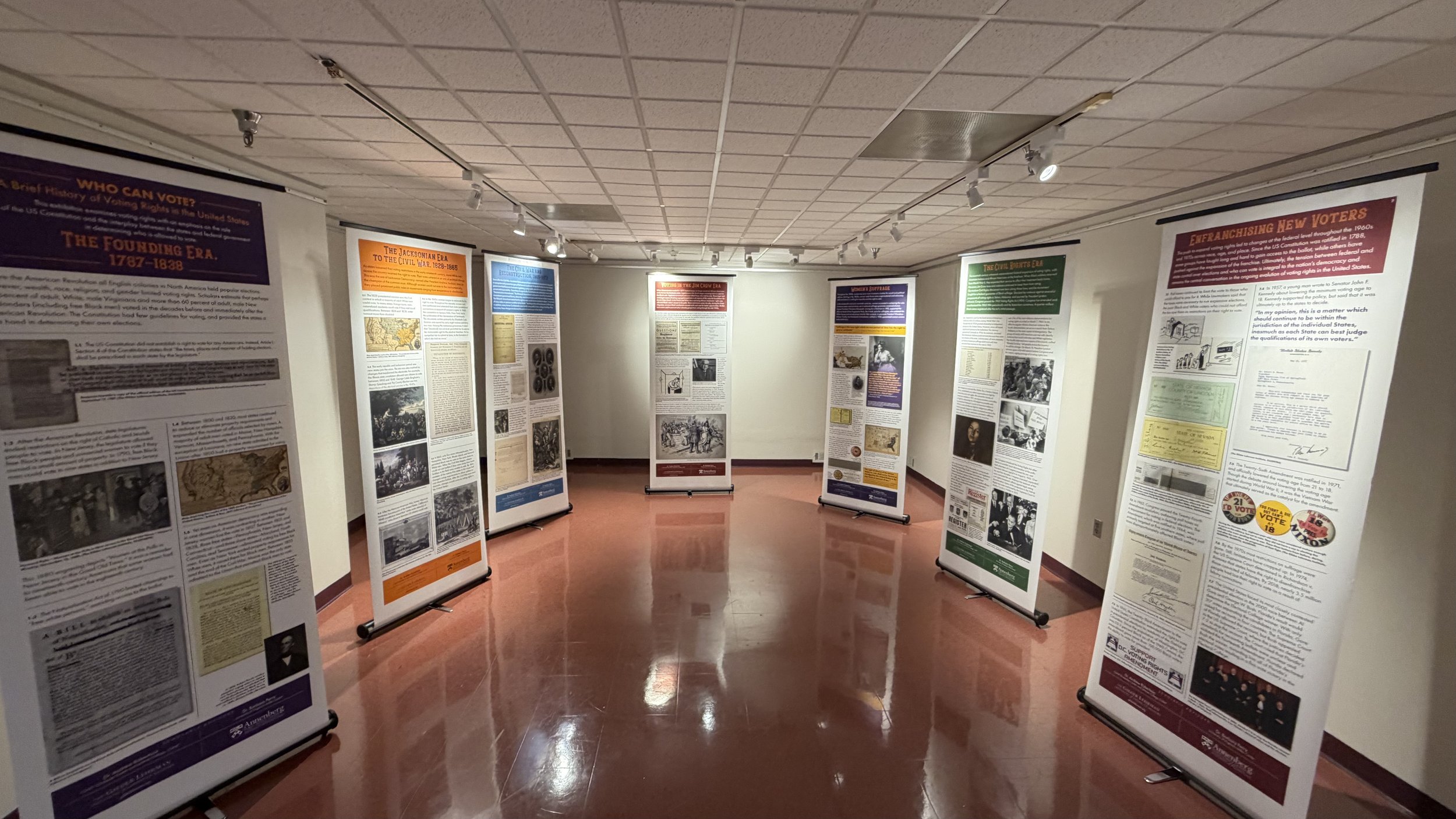 Exhibit hall at the Bruce R. Watkins Cultural Heritage Center featuring standing display panels with historical photographs and text