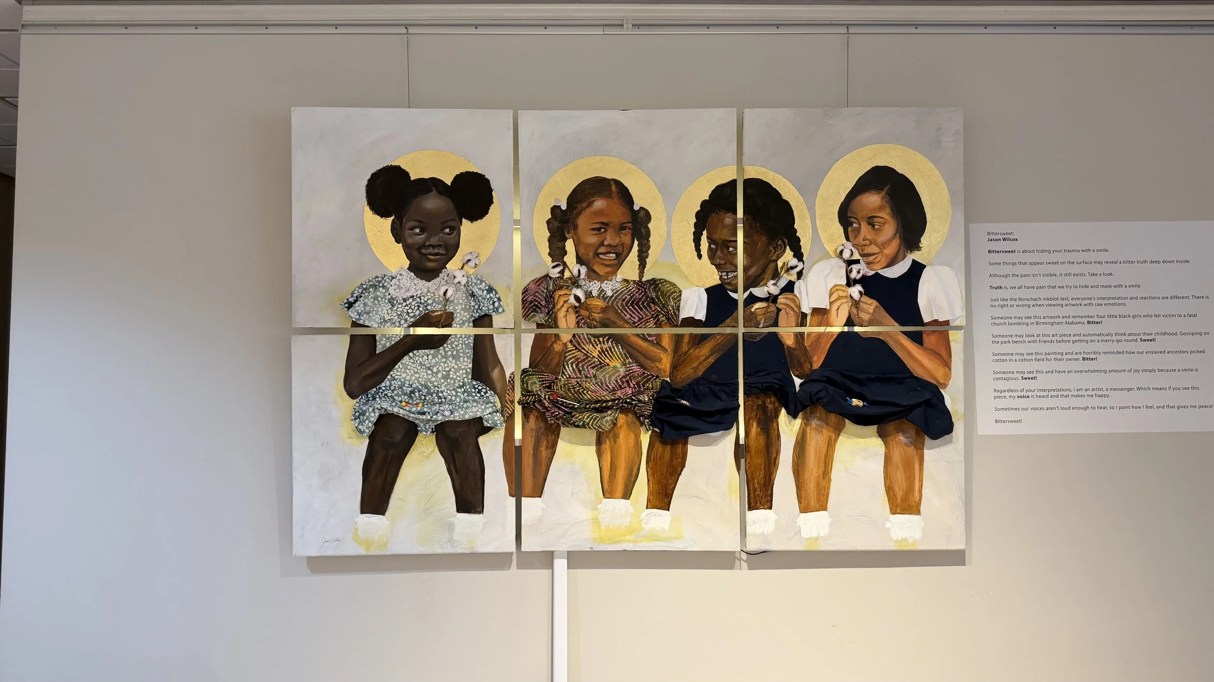 Painting of three young African-American girls on display in the gallery at the Bruce R. Watkins Cultural Heritage Center