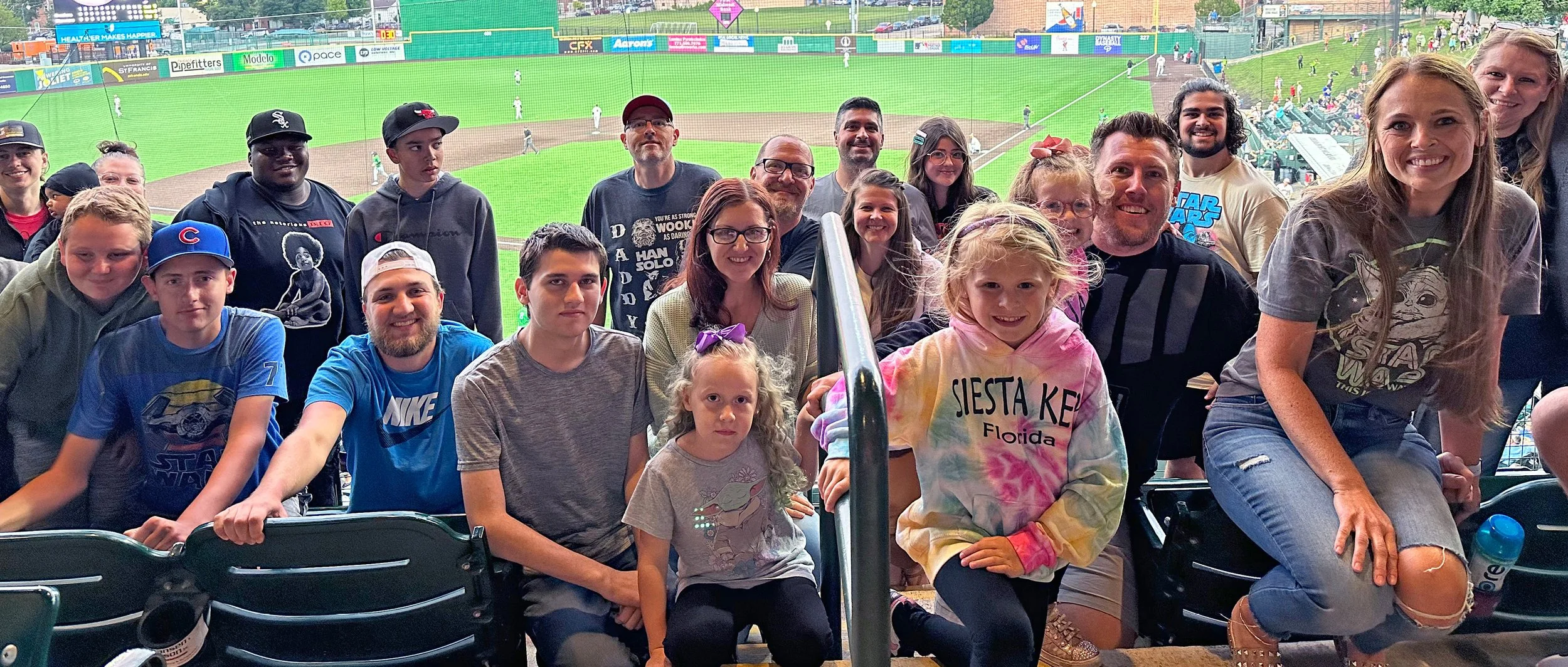 The First Place Rental team and their families at a baseball game.