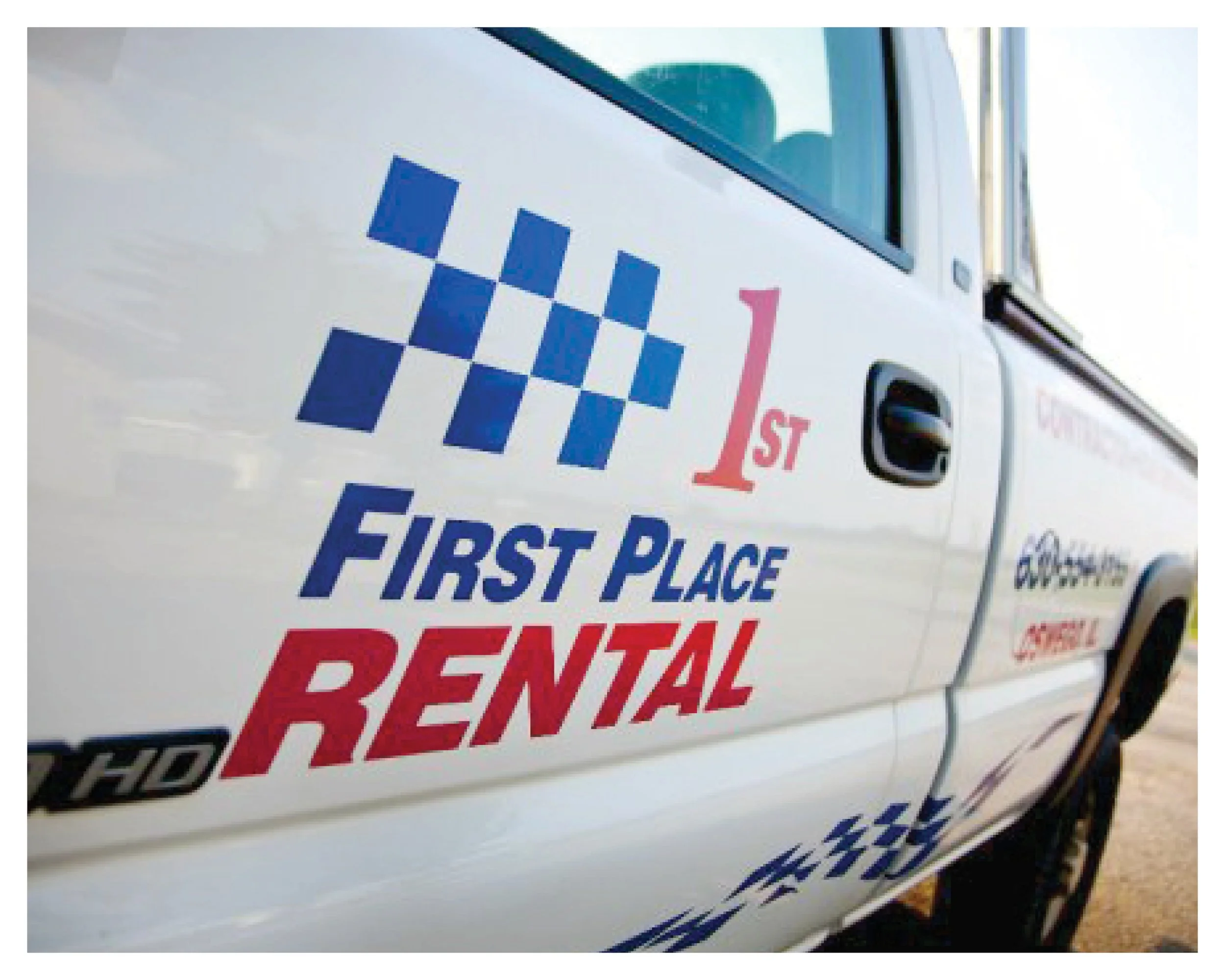 The driver's side of a First Place Rental delivery truck.