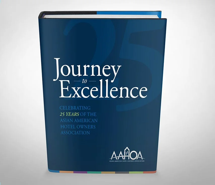 AAHOA hardcover book titled "Journey to Excellence" with the subtitle "Celebrating 25 Years of the Asian American Hotel Owners Association" and the AAHOA logo at the bottom.