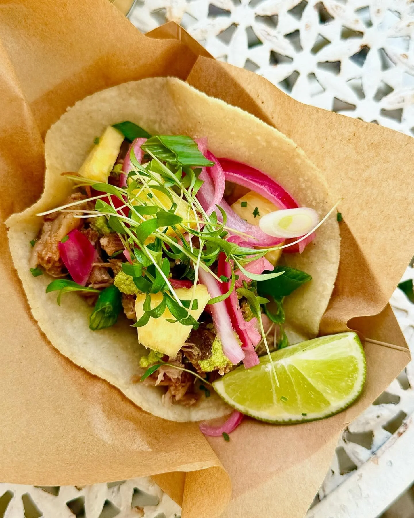 🌮 Next level tacos made with organic Duroc pork slow cooked for 12 hours, fresh hand made masa tortillas, pickled red onions, pineapple, and micro cilantro, we serve this with a spicy salsa verd&eacute;.